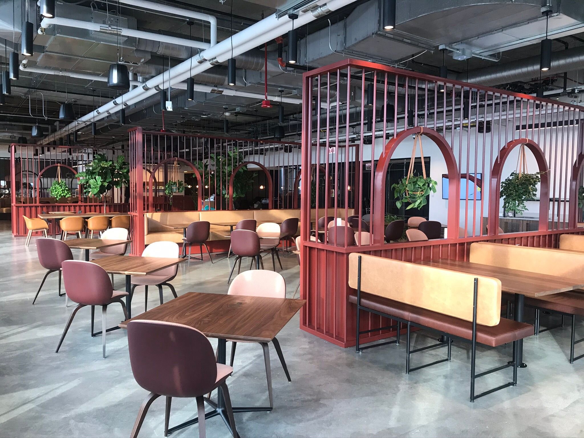 Steel space divider with custom red powder coat + steel booth frames in matte black
