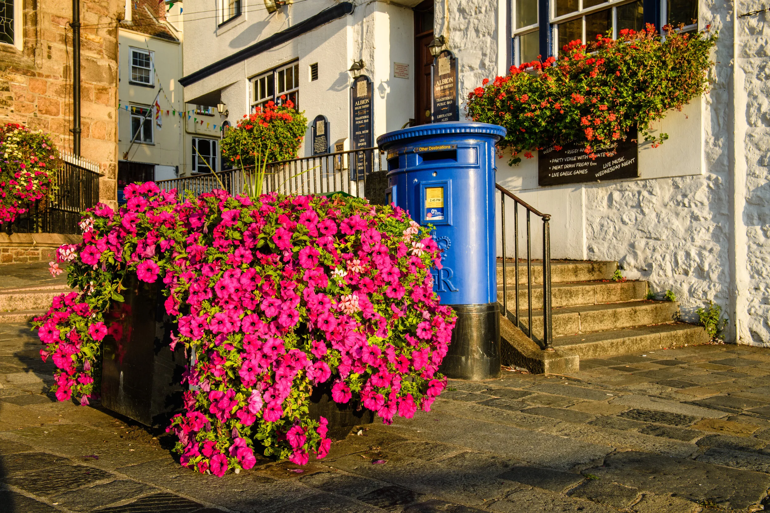 Blue Guernsey post box outside the town church in St Peter Port, Guernsey
