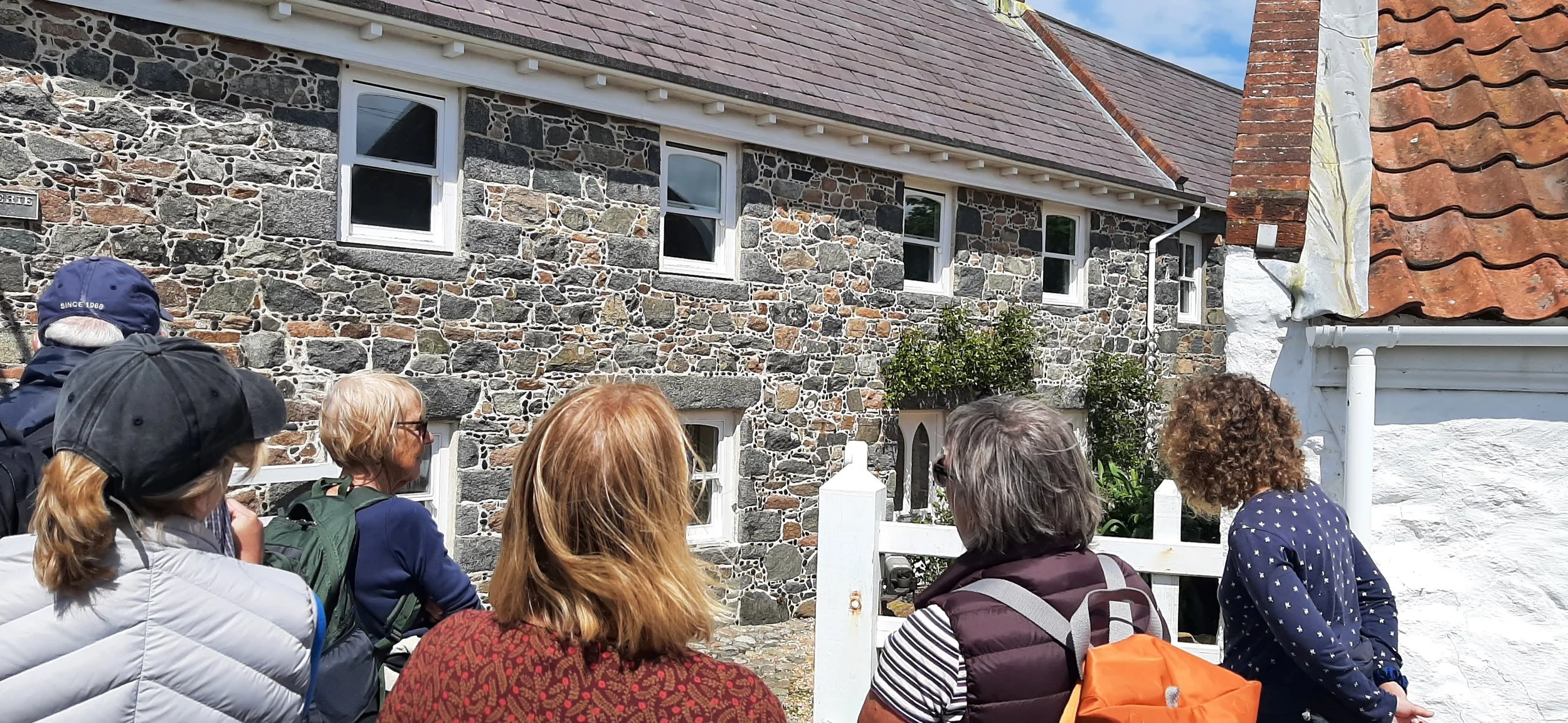 Rachel pointing out historic Guernsey landmarks to a group