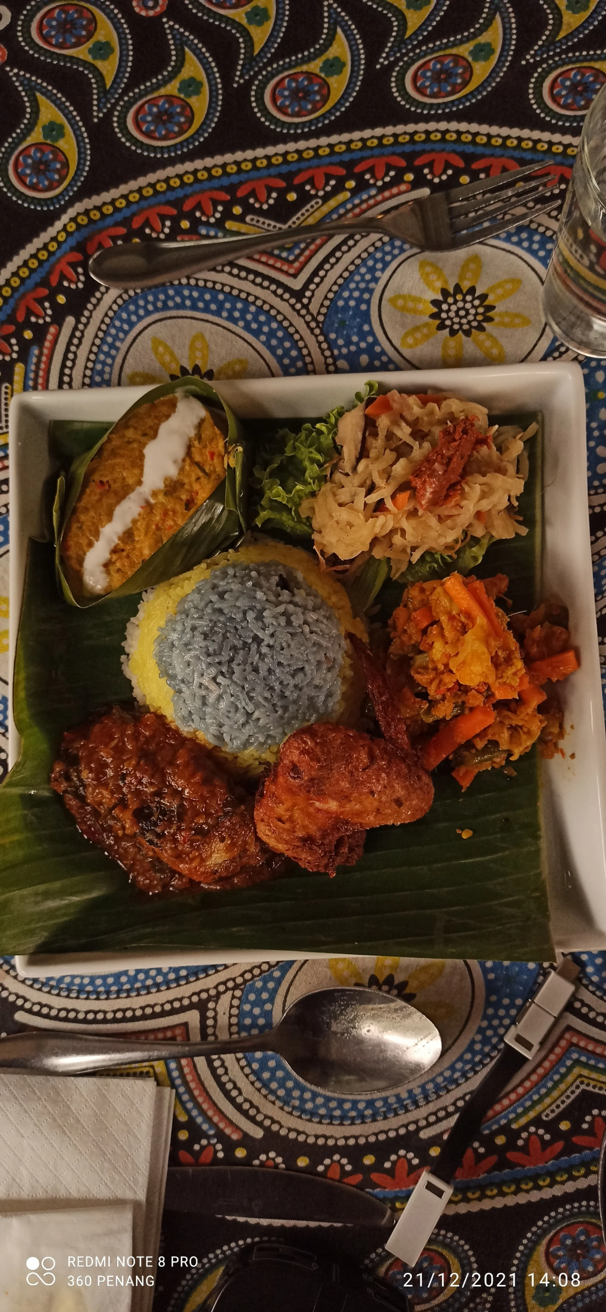 Blue rice tasting platter with Achar (pickles), Enche Kabin (fried chicken), Asam fish, Jiu Hu Char (mengkuang with squid) Otak otak with scallops (egg custard)