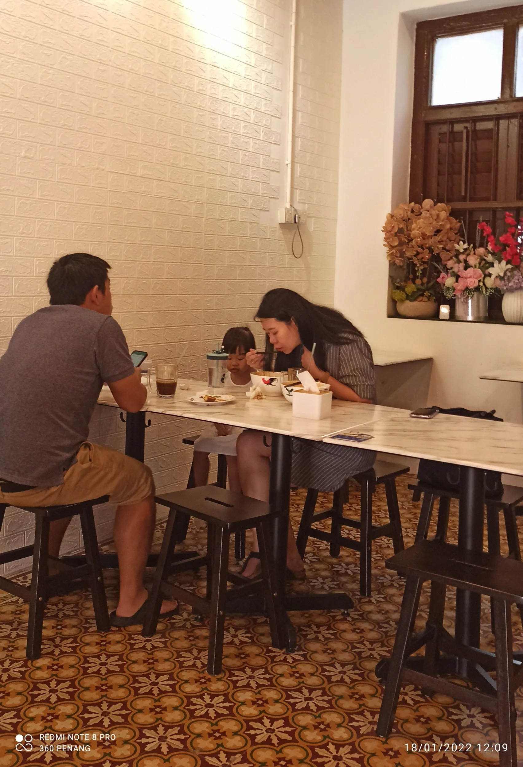 Customers. Note no frills tables and chairs