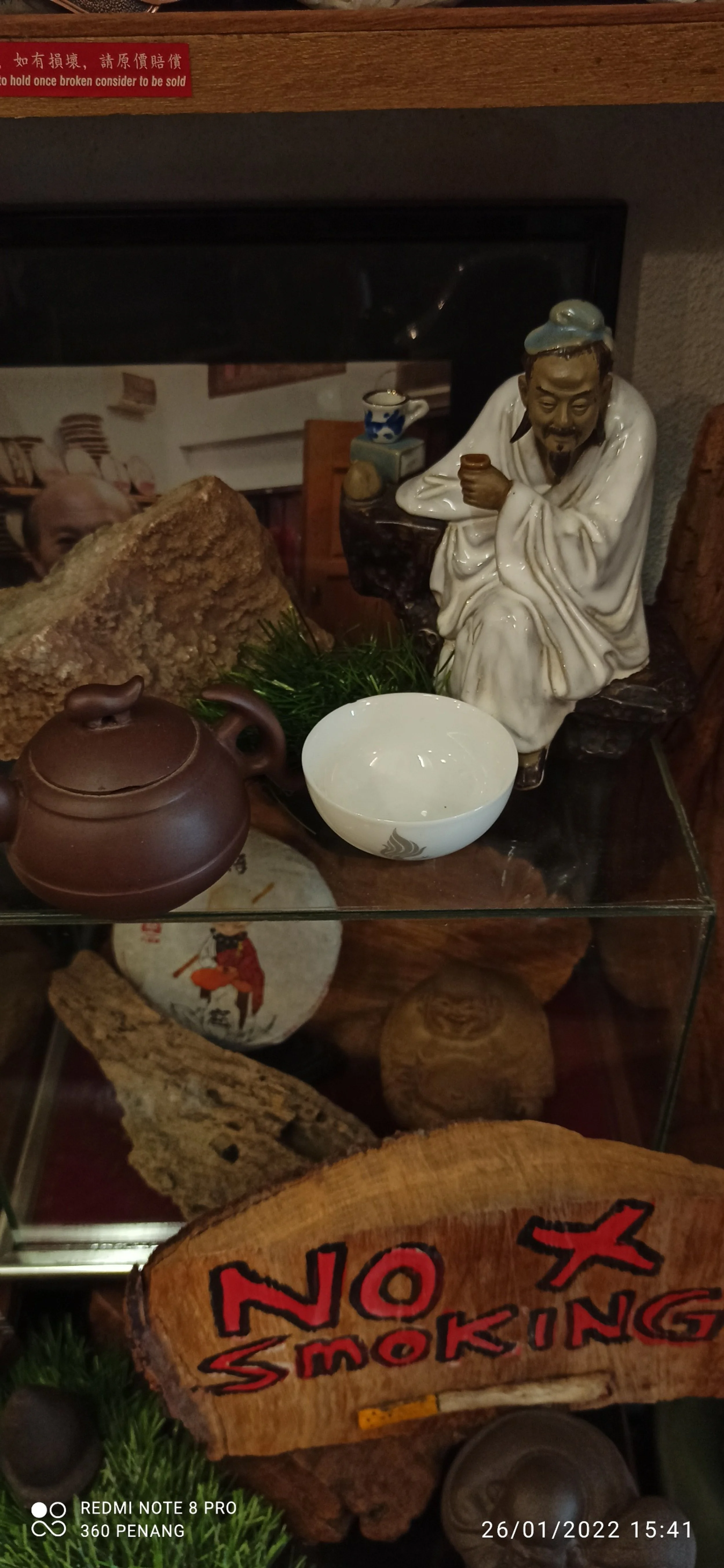 Figurine of a tea drinker