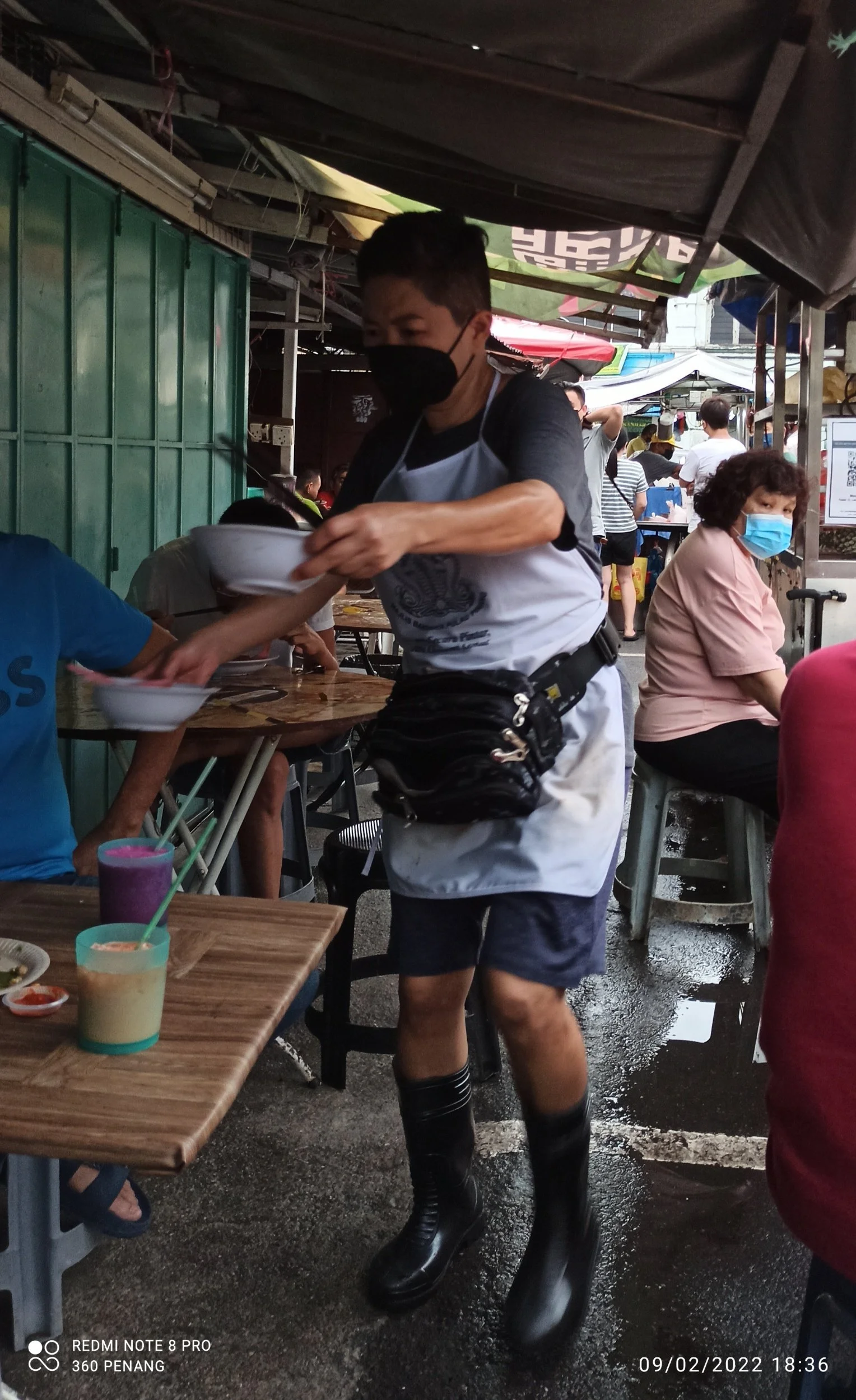 The Wan Tan Mee stall holder delivering bowls
