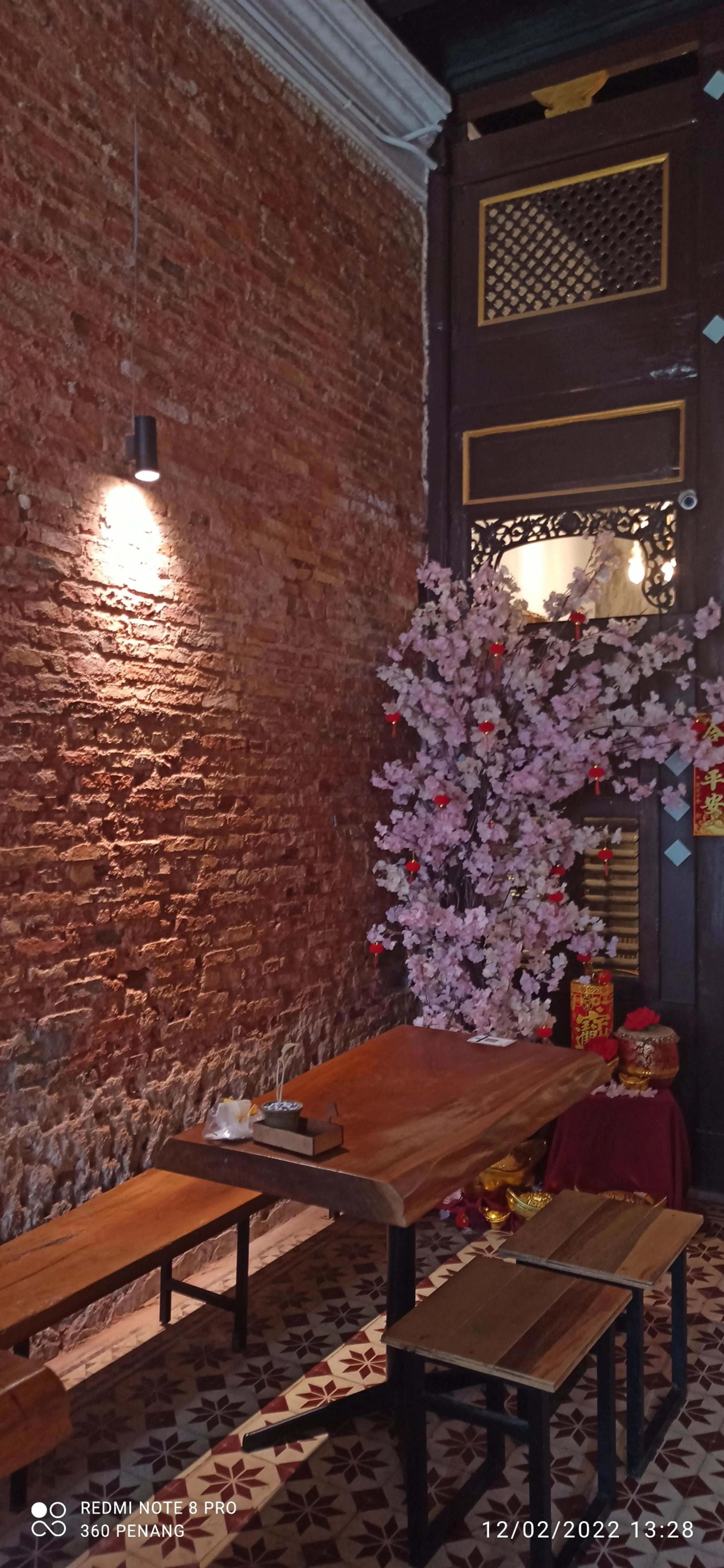 Note exposed brickworks walls and tree trunks repurposed as bench seating