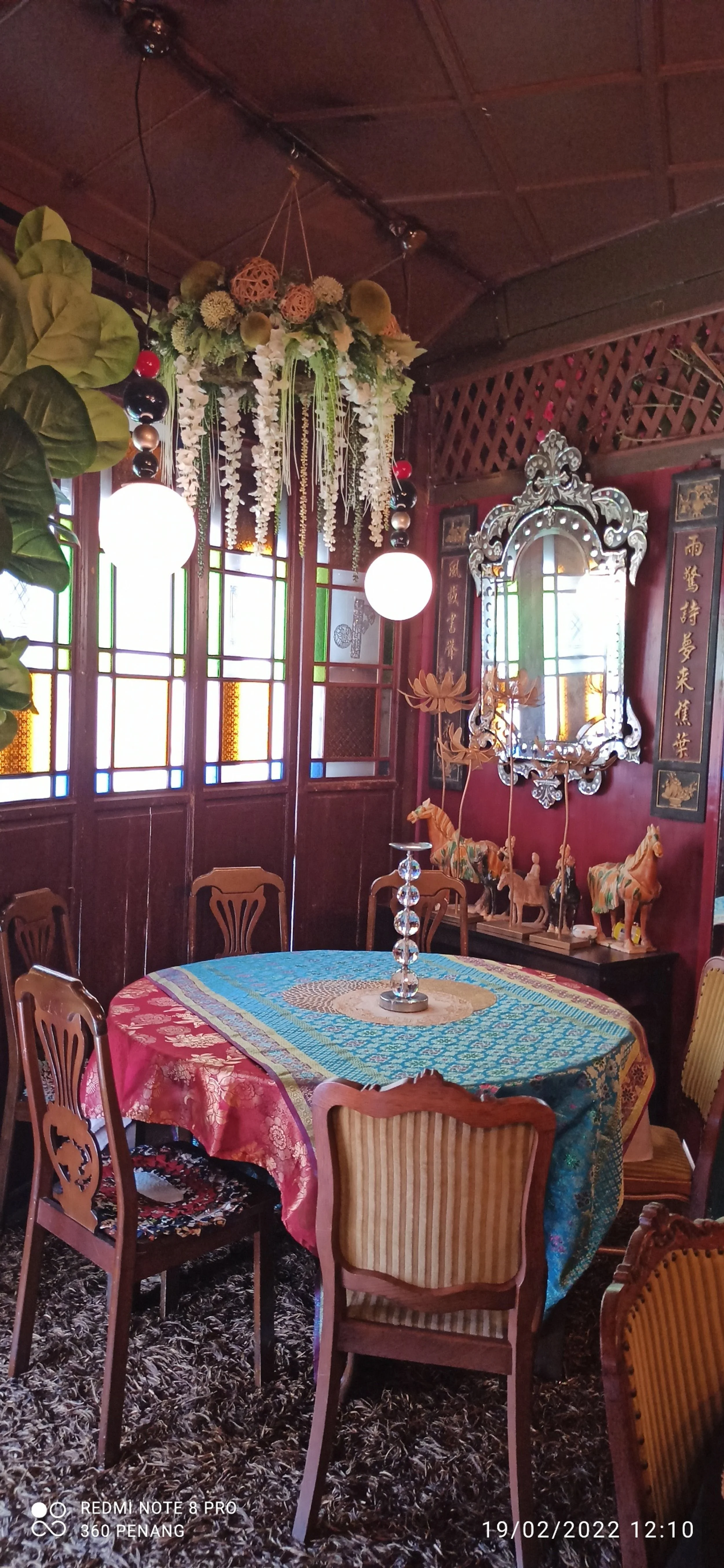 Private dining room facing road- note Venetian mirror, Tang Dynasty clay horses, Art Deco chairs