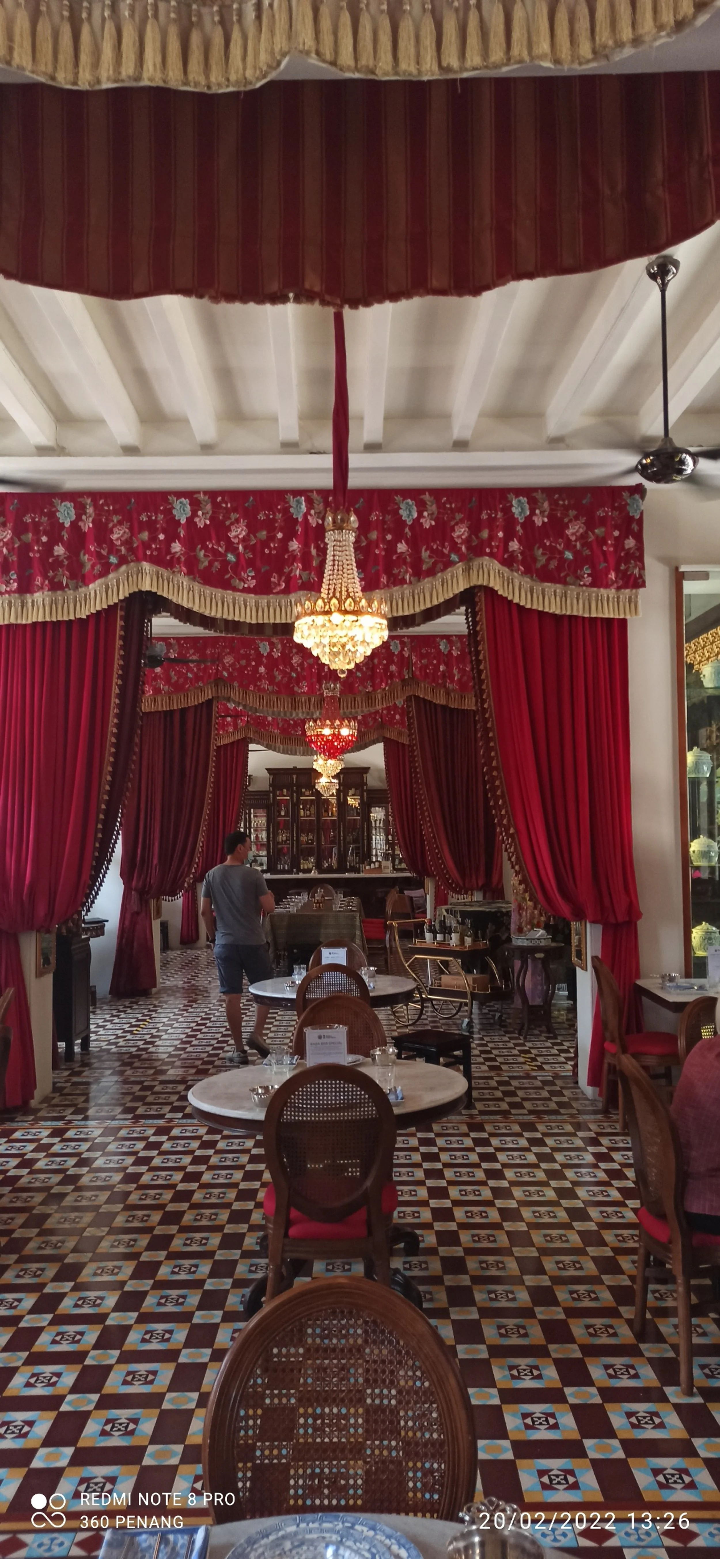 Red brocade drapery and chandeliers