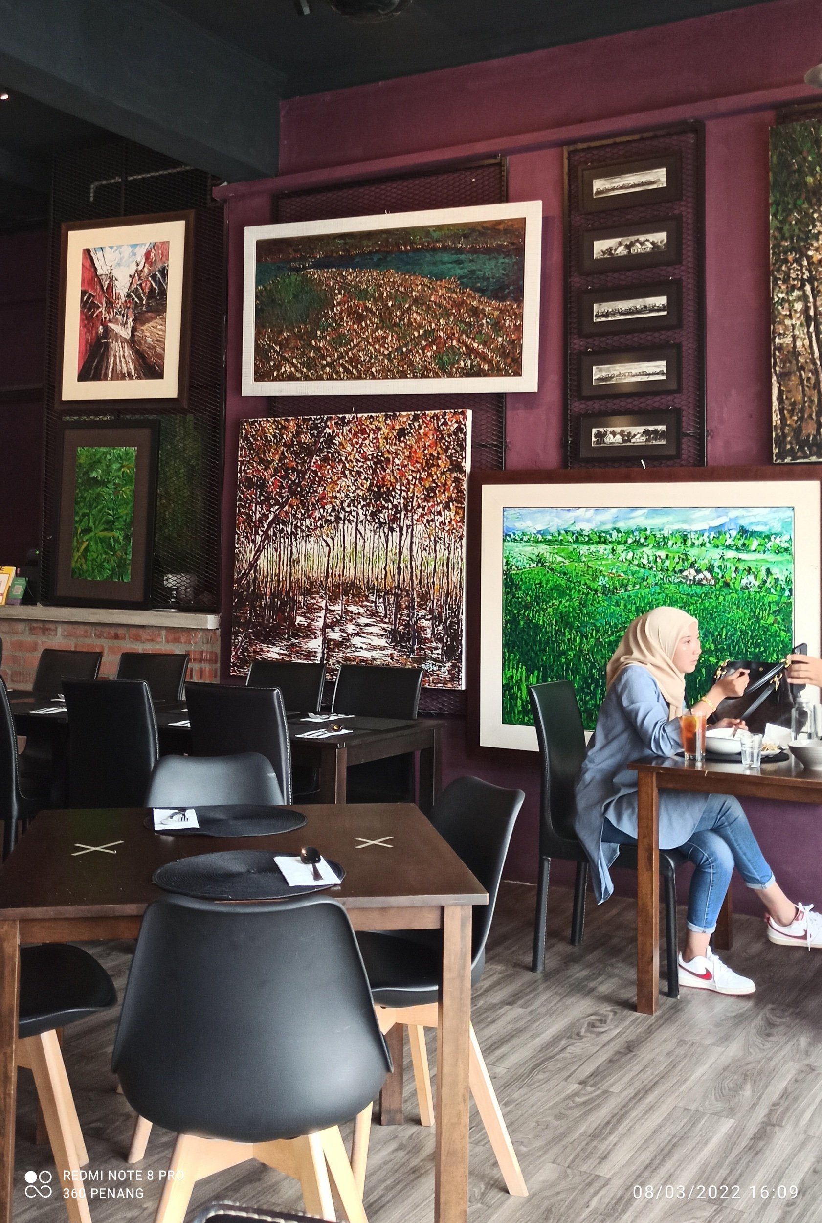 Oil paintings adorn the purple coloured feature walls