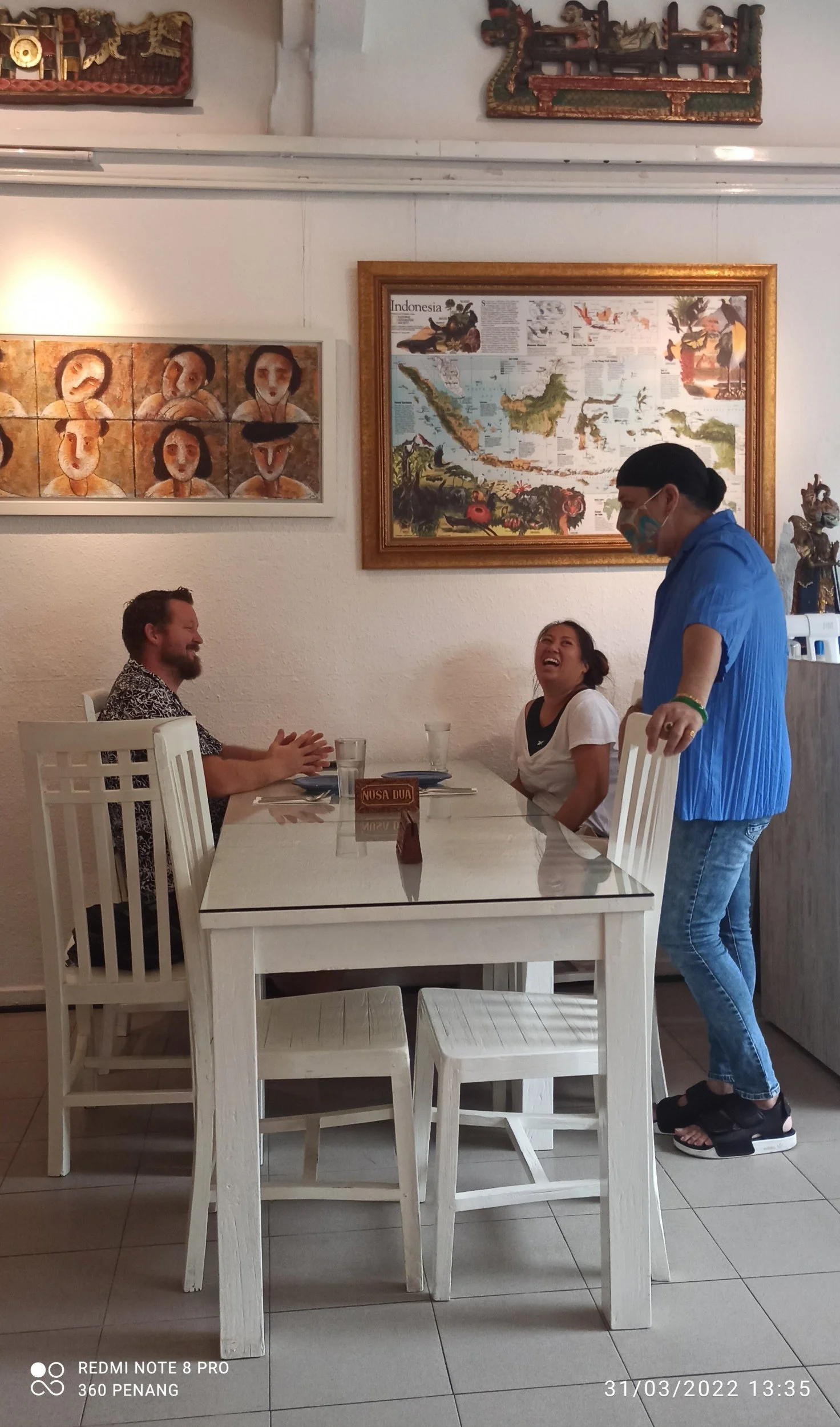 The chef in blue with diners