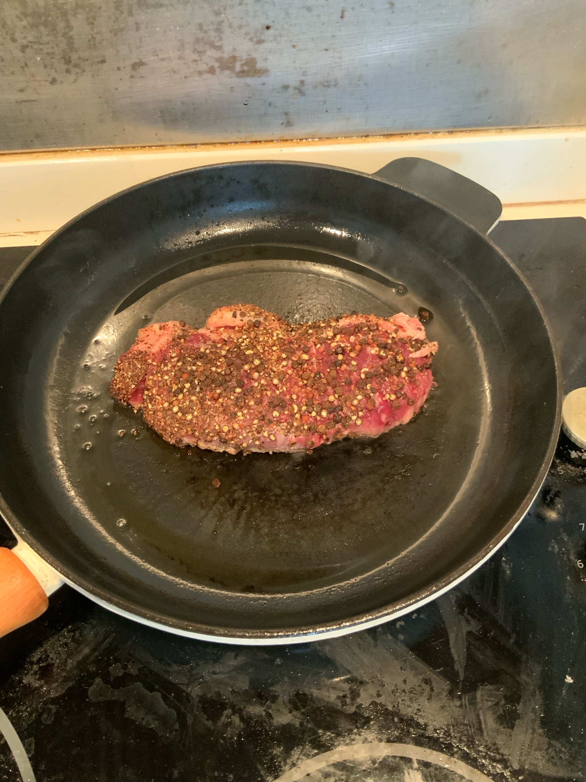 Searing steak in a hot cast iron skillet