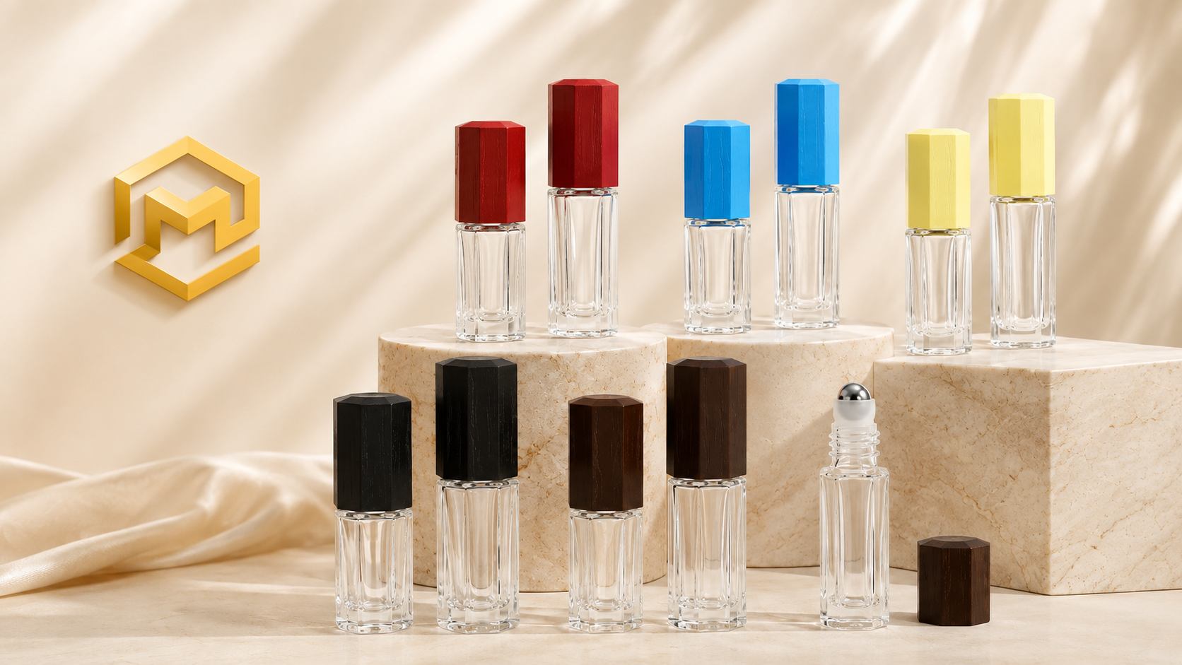 Display of ten small glass perfume bottles with different colored caps arranged on marble pedestals, with a gold geometric logo on a beige satin background.