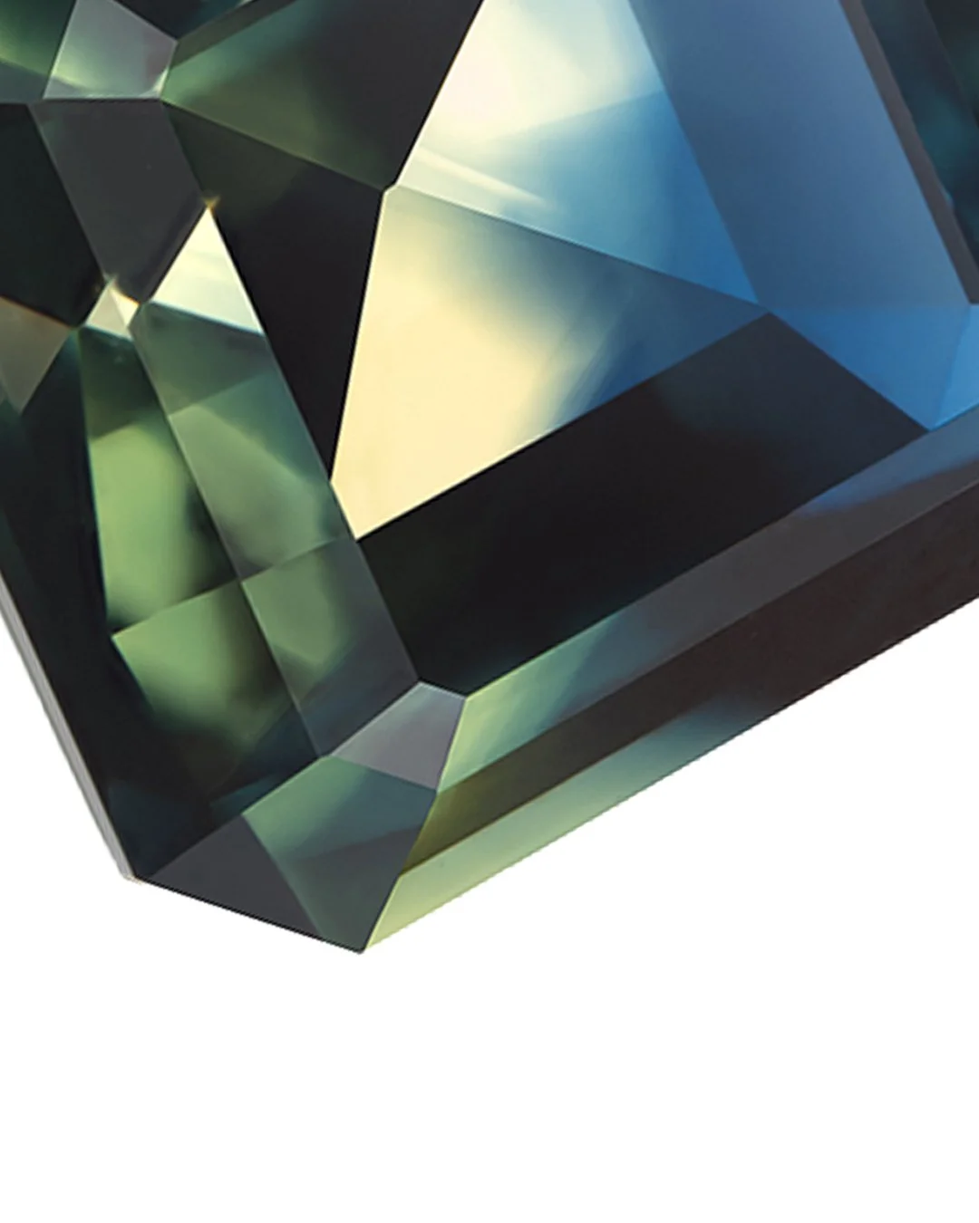 Focus stacked photograph of a 3.56 ct Australian blue green sapphire with a square emerald cut, showing geometric facets and deep blue, green and pale yellow reflections.