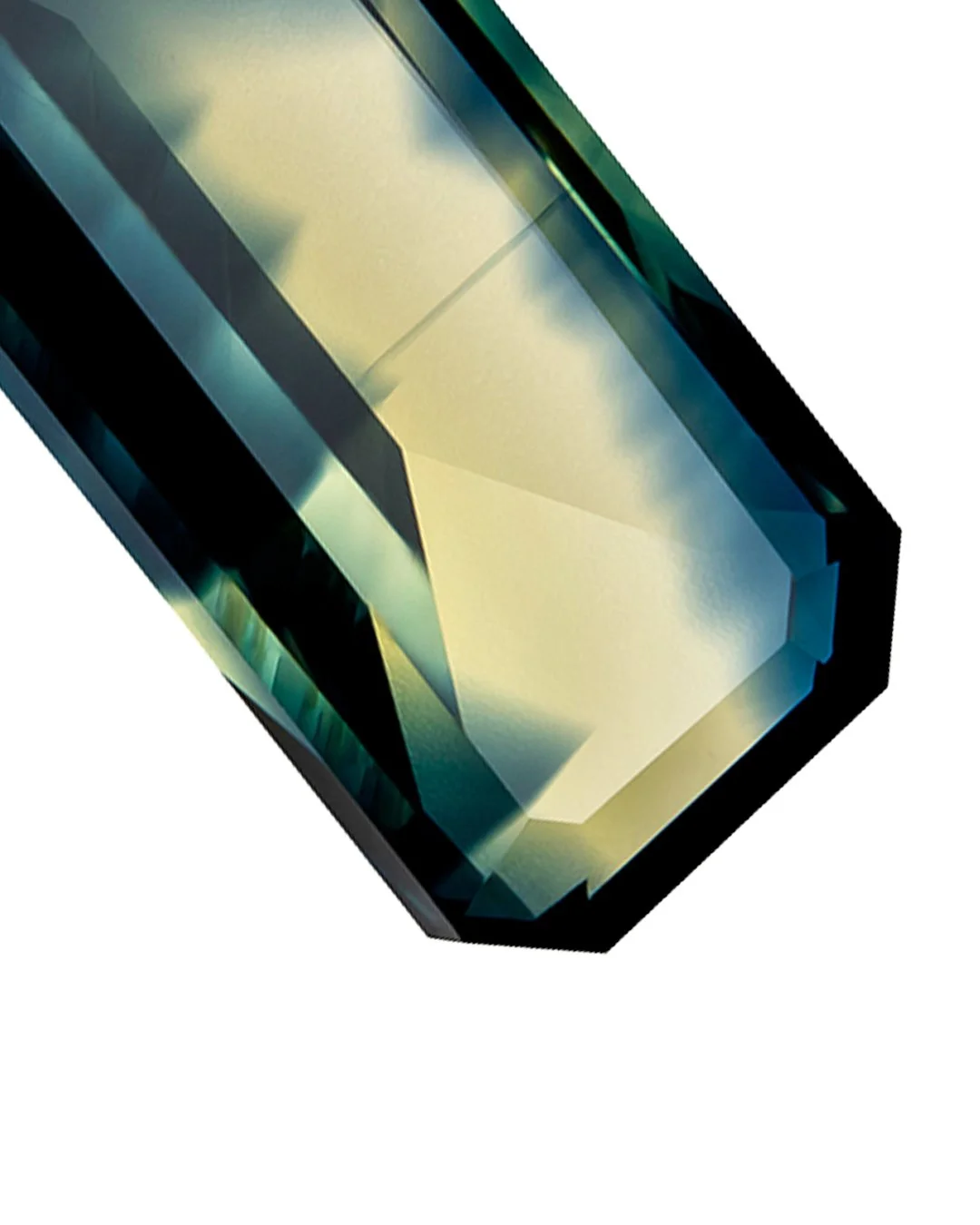 Focus stacked photograph of a 1.65 ct Australian blue yellow parti sapphire with an emerald cut, revealing angular facets and contrasting blue and pale yellow colour.