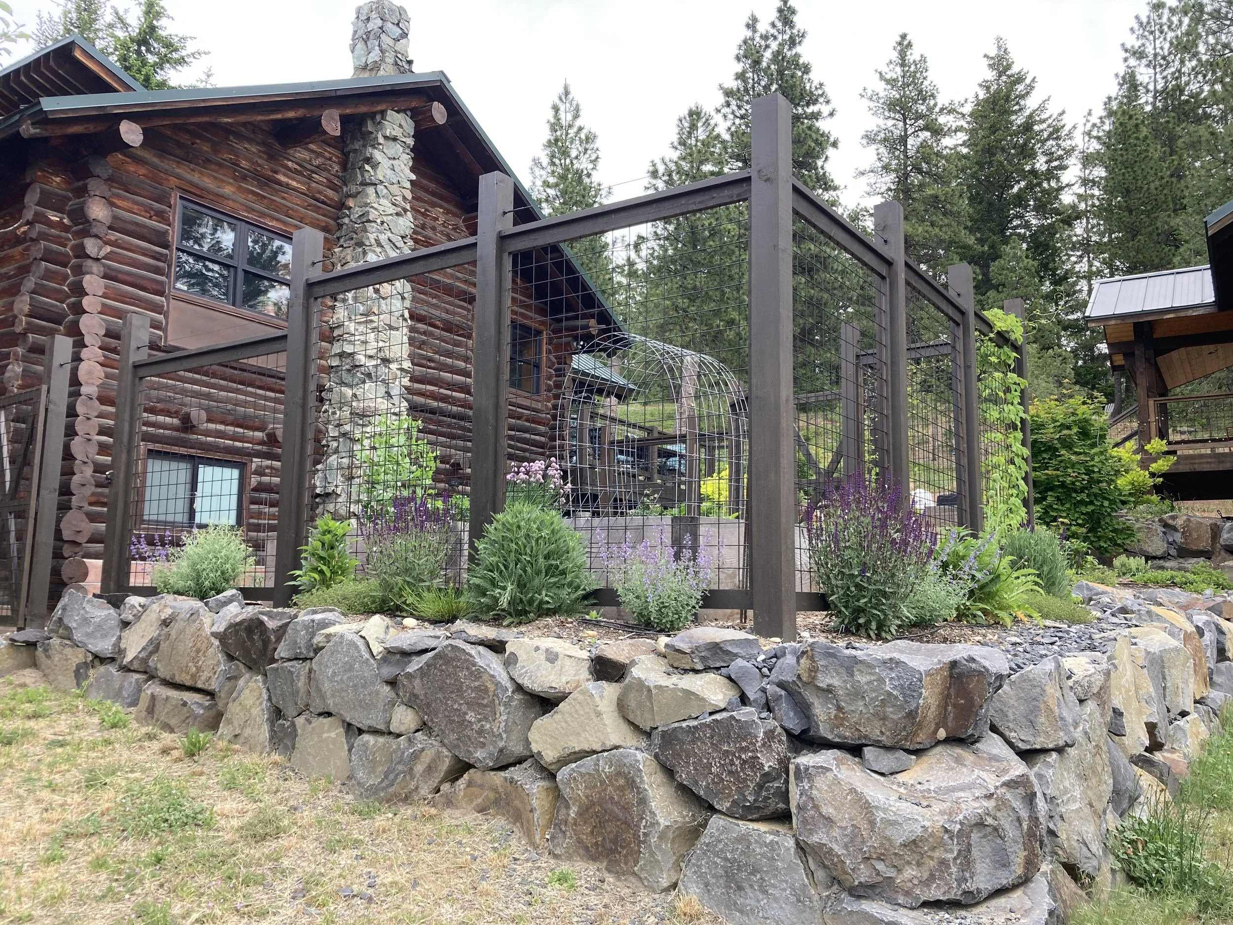 Spring - Drought tolerant, deer resistant perimeter garden. The retaining wall was done by Jason Merritt. 