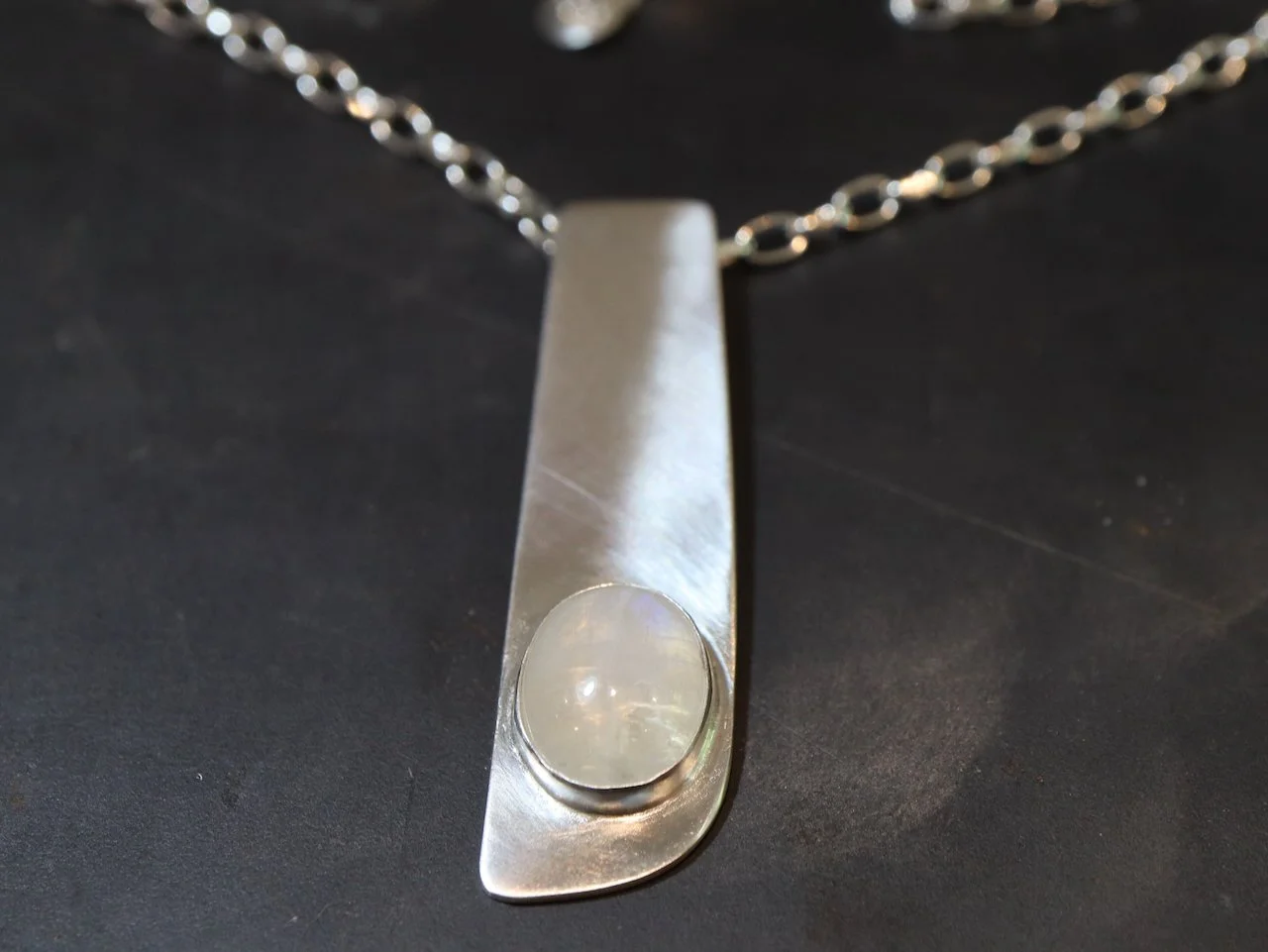 a recycled Moonstone Cabochon, a stunning silver drop pendant