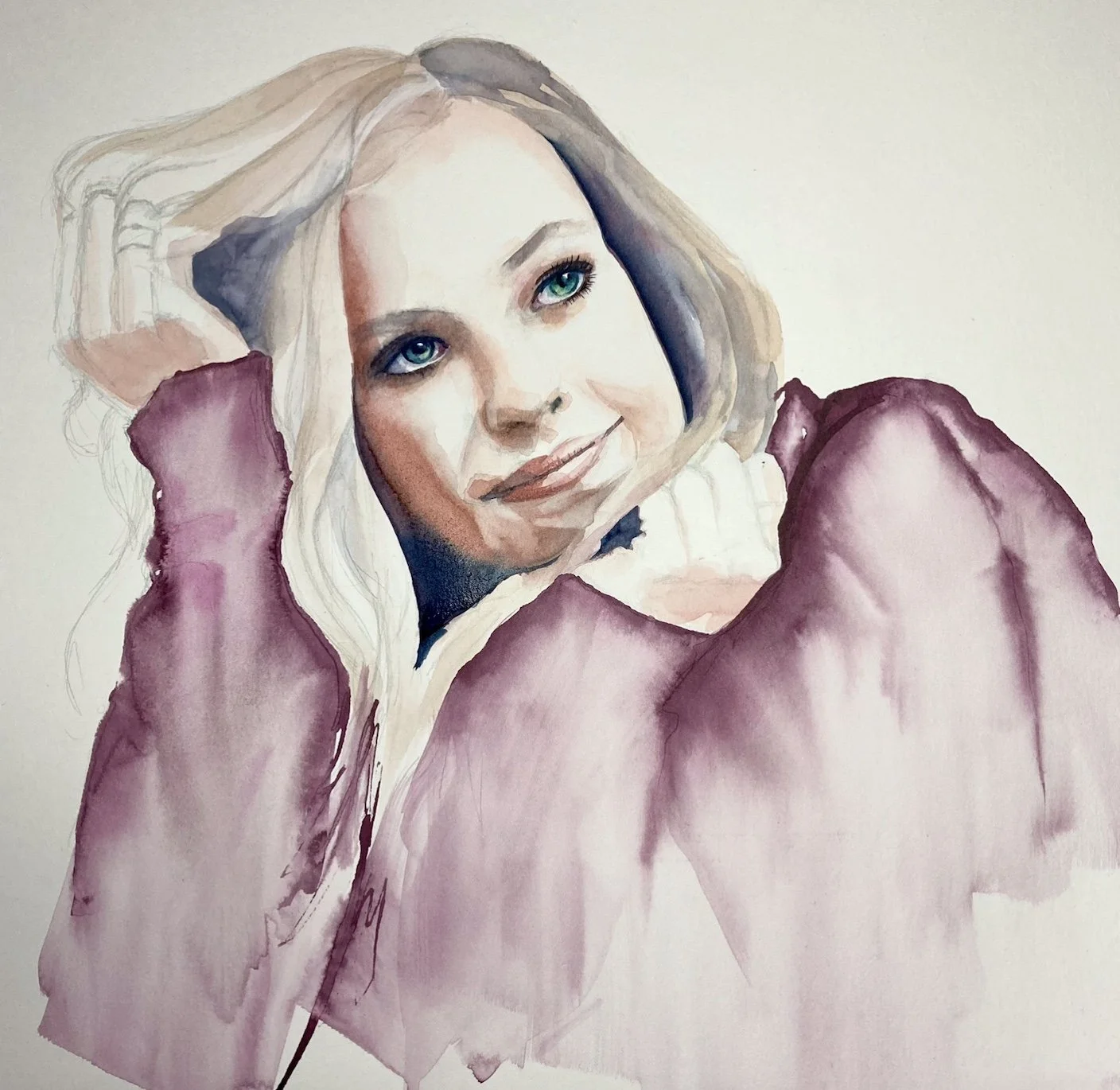 Watercolor portrait of a woman with blonde hair, blue eyes, and a gentle smile, resting her head on her hand, wearing a purple jacket.