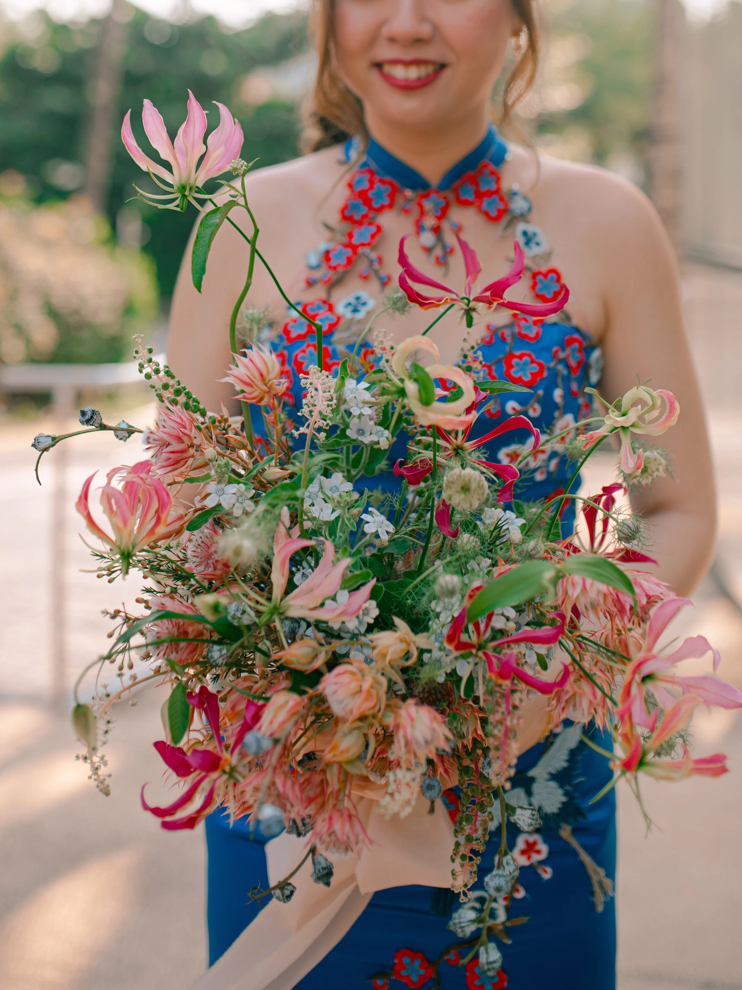 Red gloriosa lilies mimicked cranes in flight, which were a unique embroidery feature of the gown.
Gown design: Rico-A-Mona Bridal.
Image Credits: Nicole from Patchwork Pictures