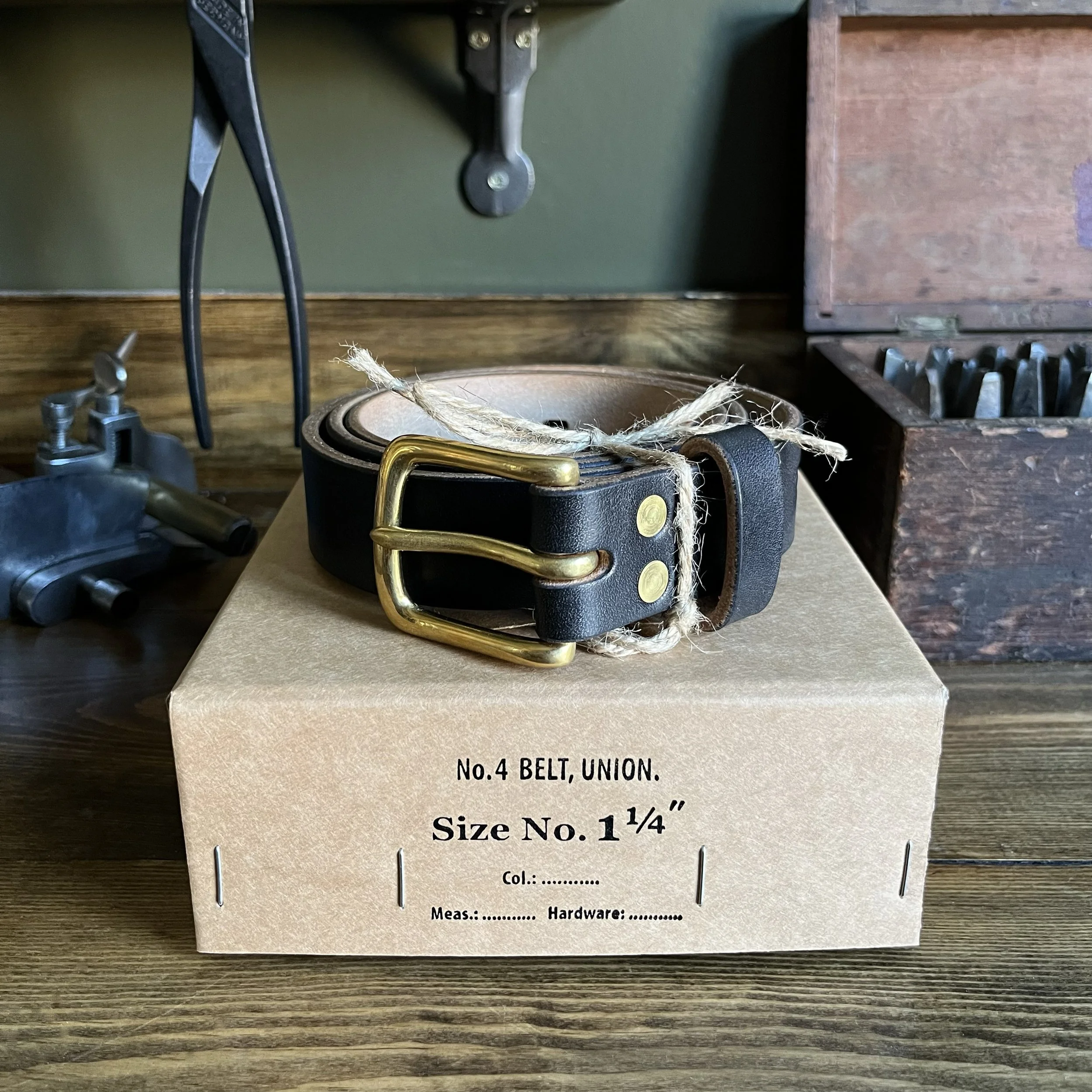 Handmade Black Leather Belt with Brass Buckle on Vintage Box