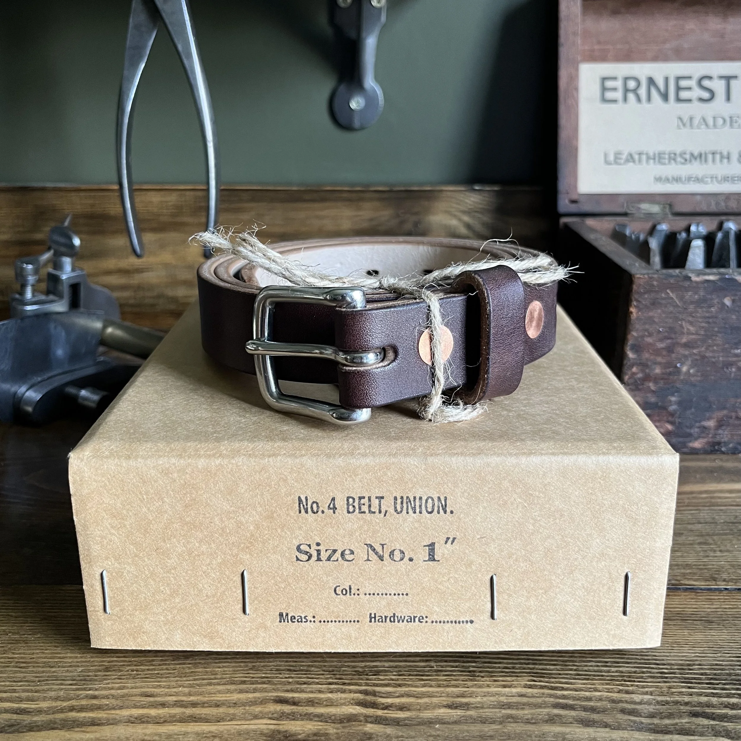 Handmade Thin Leather Belt with Silver Buckle on Vintage Box