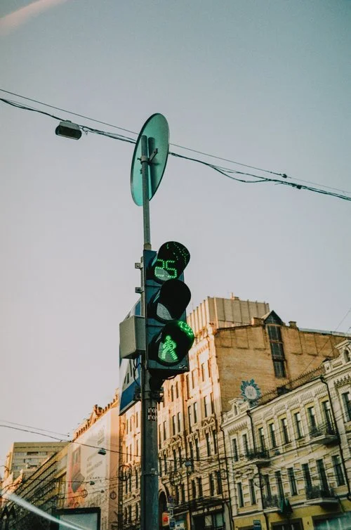Image of crosswalk road sign with green lights on