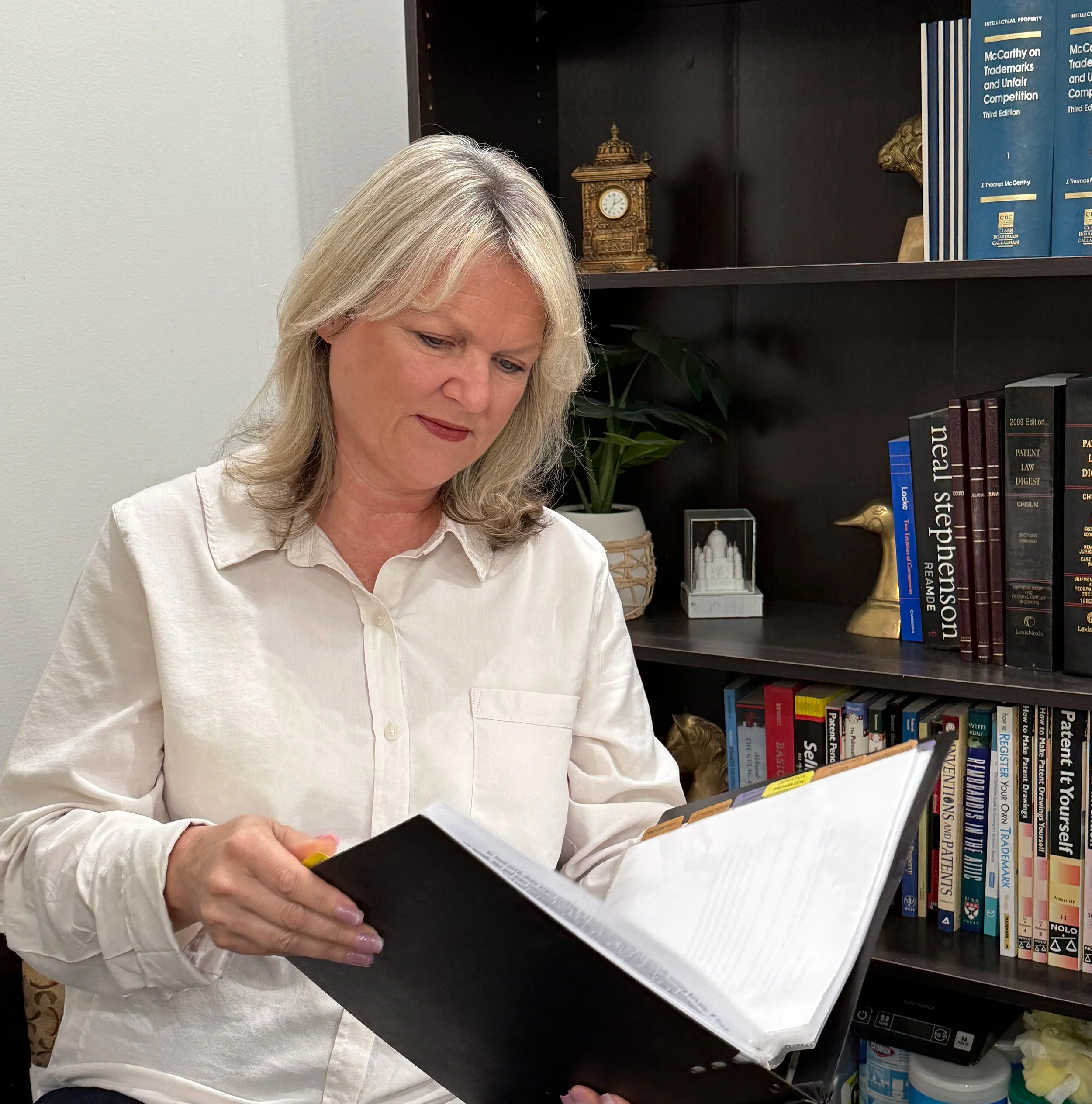 Professional reviewing documents at Karich & Associates, representing intellectual property and patent services