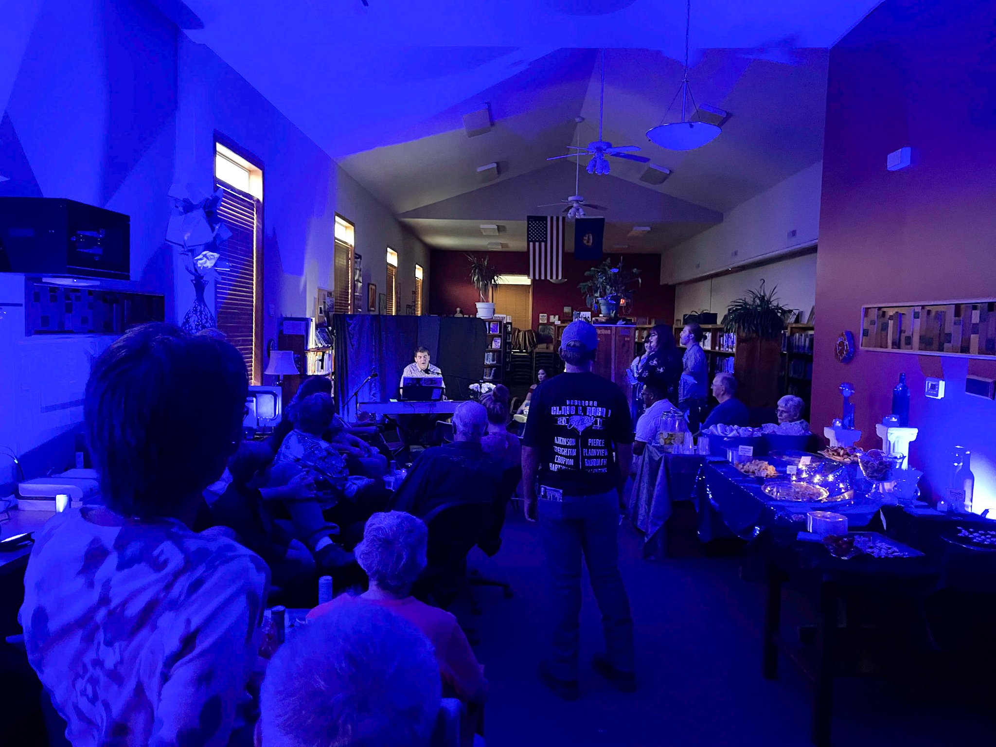 crowd listens to singer at album release party