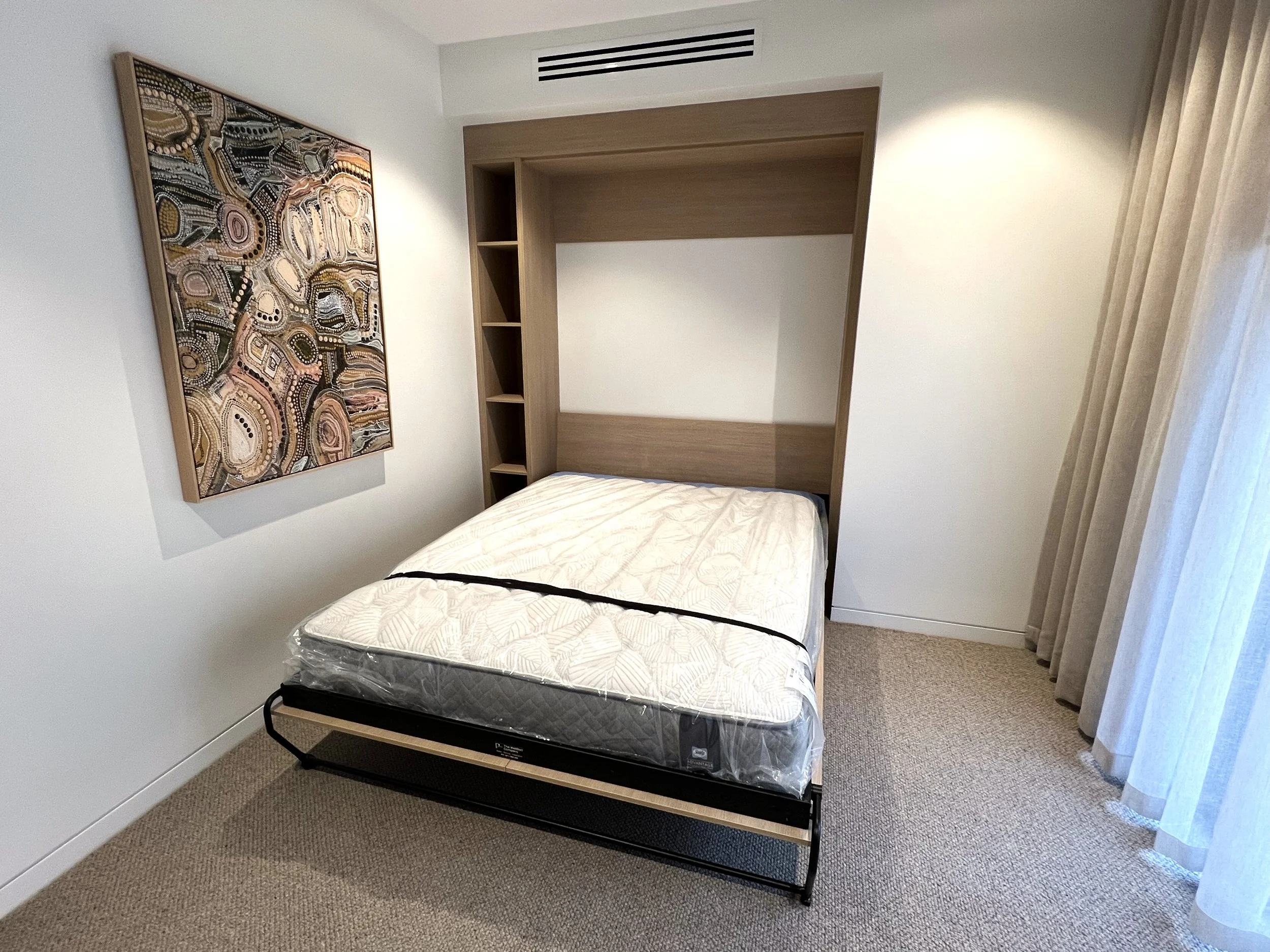 Queen Alpha bed and bookcase fitted in wall niche