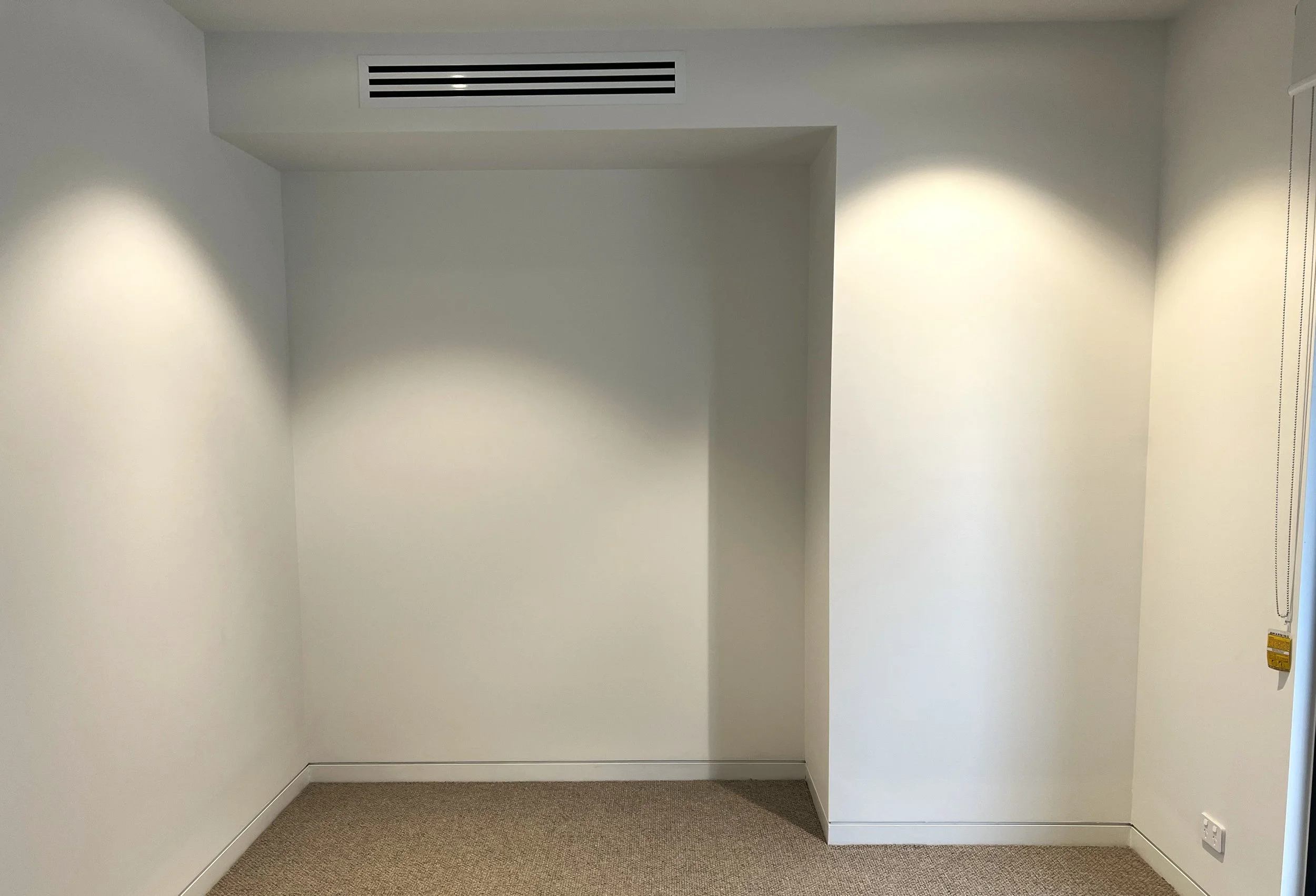 Queen Alpha bed and bookcase fitted in wall niche