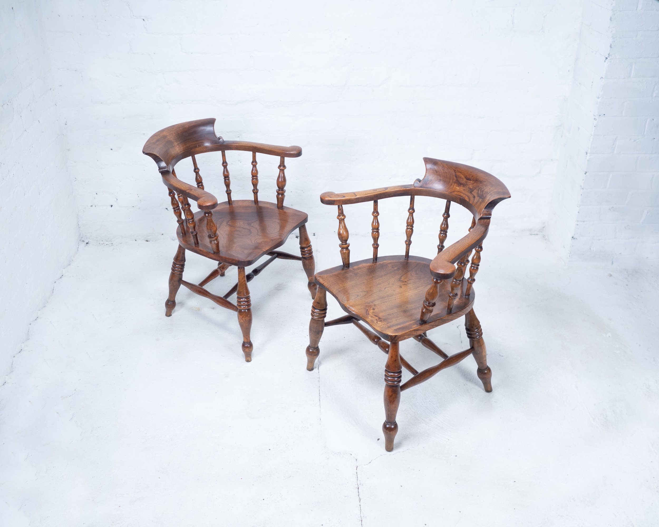 A Pair of Antique Oak Bow Smokers Chairs