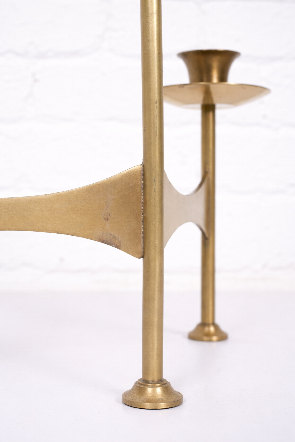 Brass candlestick with subtle wear.png