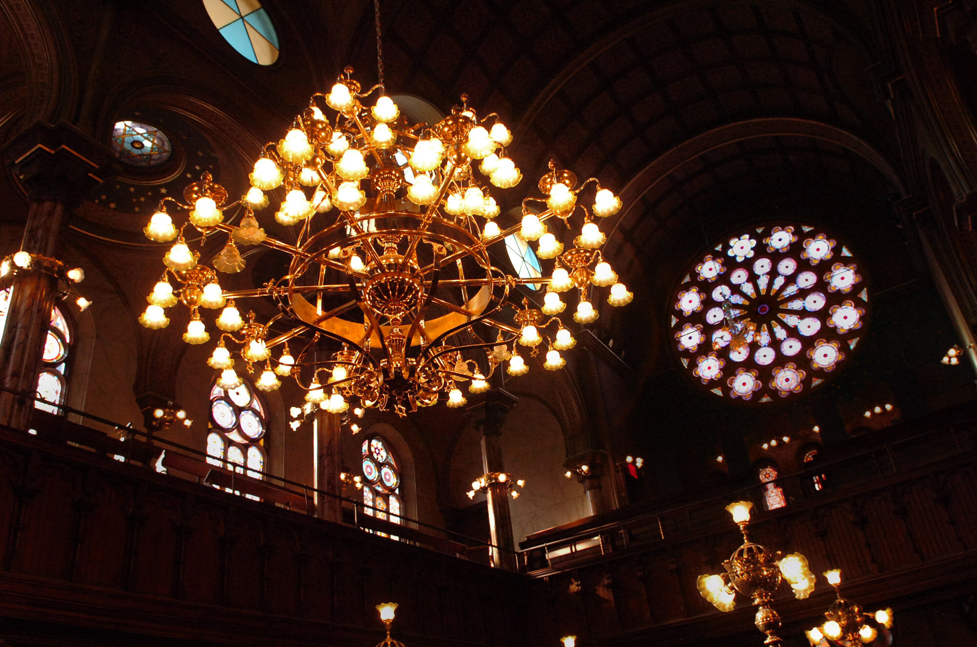 Restored chandelier with restored stained glass window