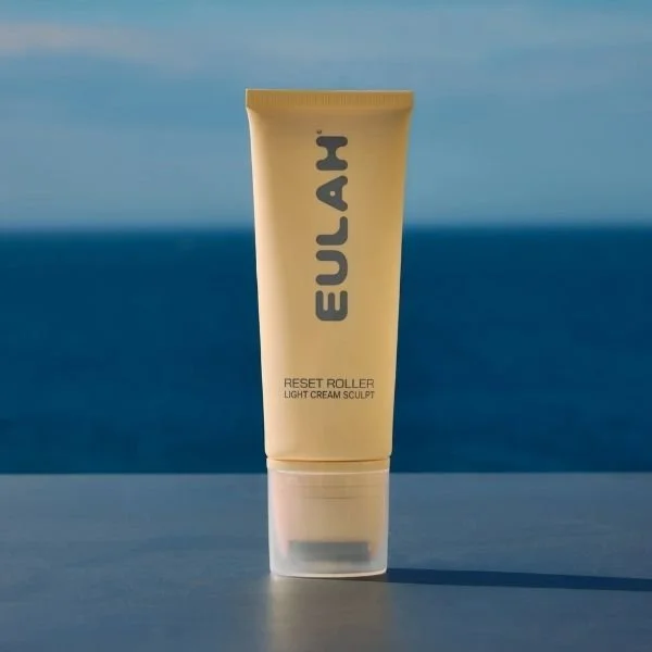 A skincare product in front of the sea