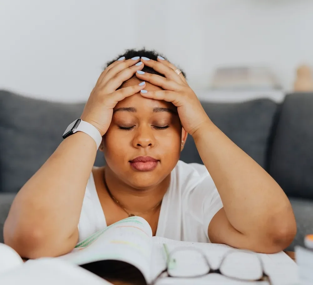 woman looking overwhelmed with hands on head
