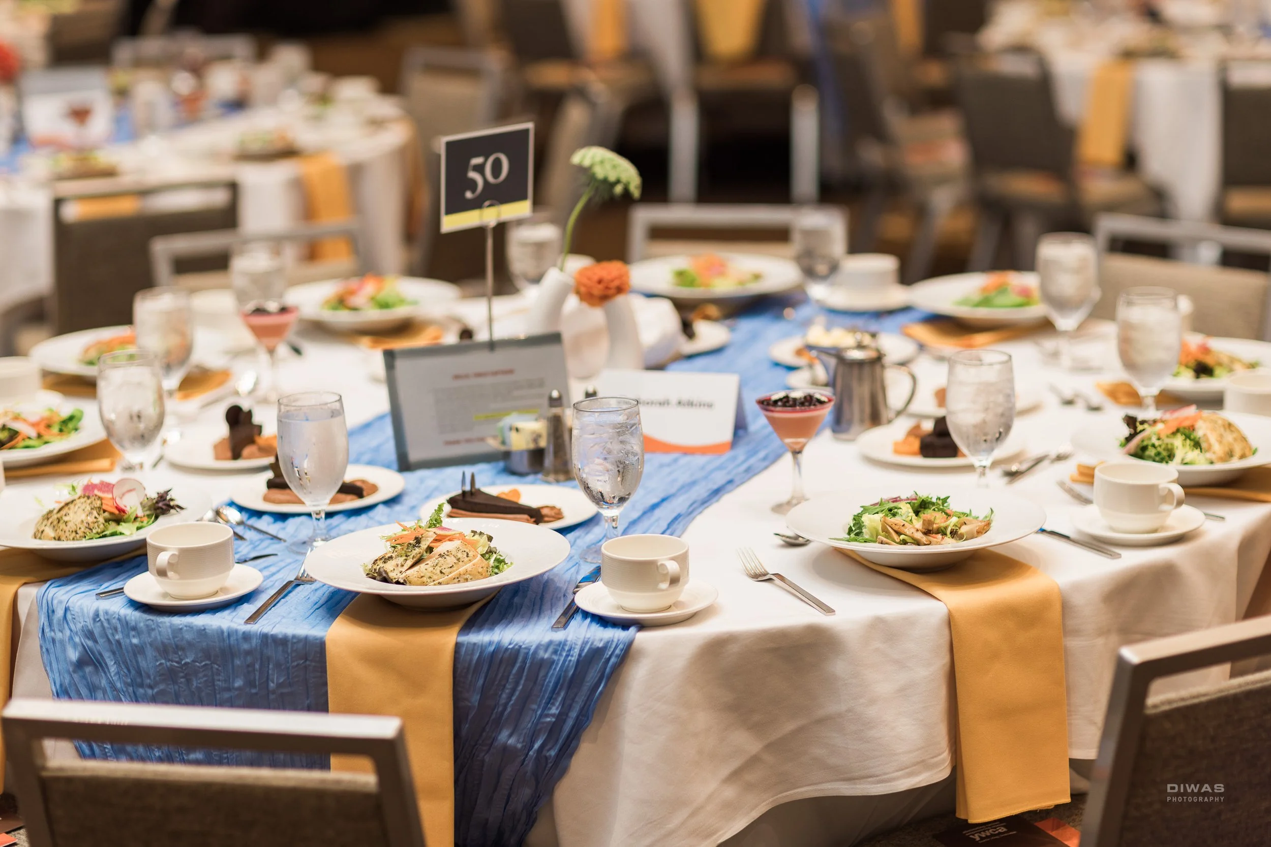 a close-up image of a round table with no guests and plated appetizers ready on the table.