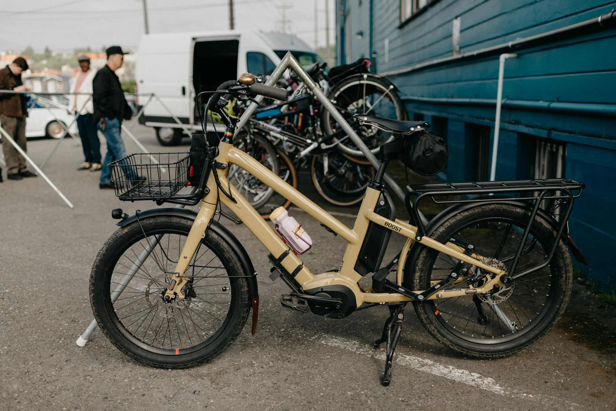 A row of bikes parked at a bicycle designated parking space beside a building.