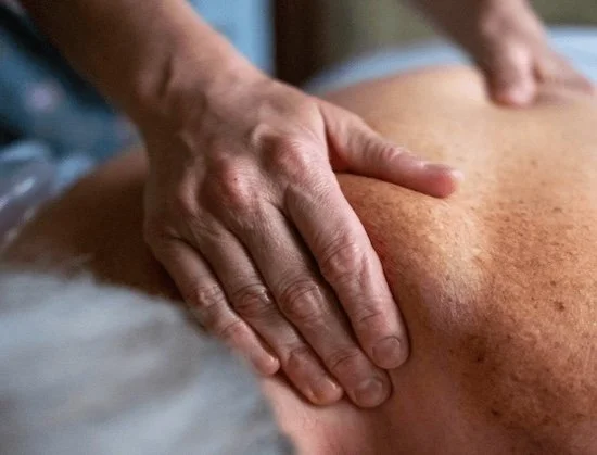 A client receives myofascial release for neck pain relief in SoDo, Seattle