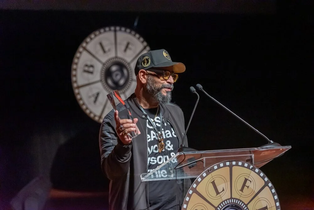 Man receiving an award at Bronze Lens Film Festival