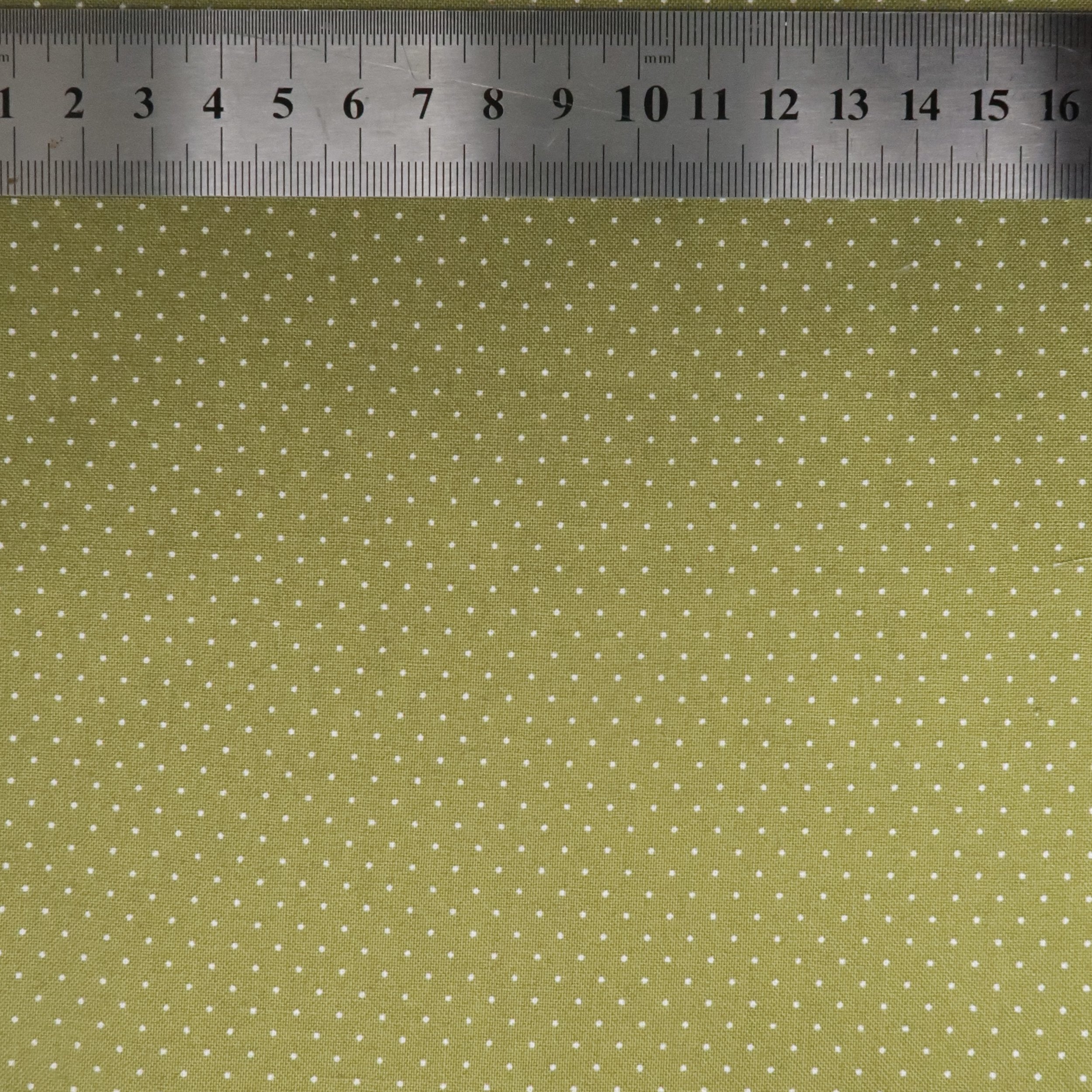 Tiny white dots on green fabric