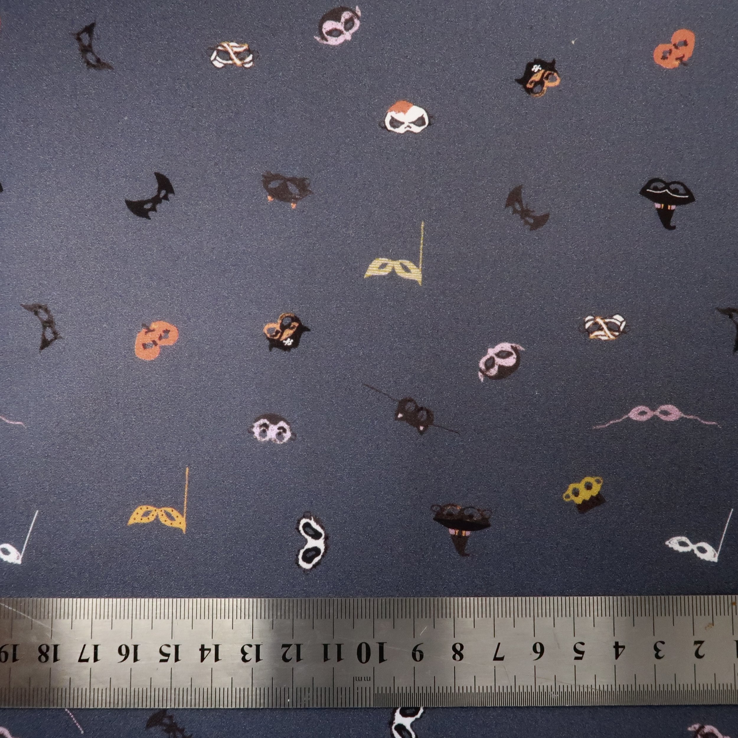 Halloween masks on slate grey fabric
