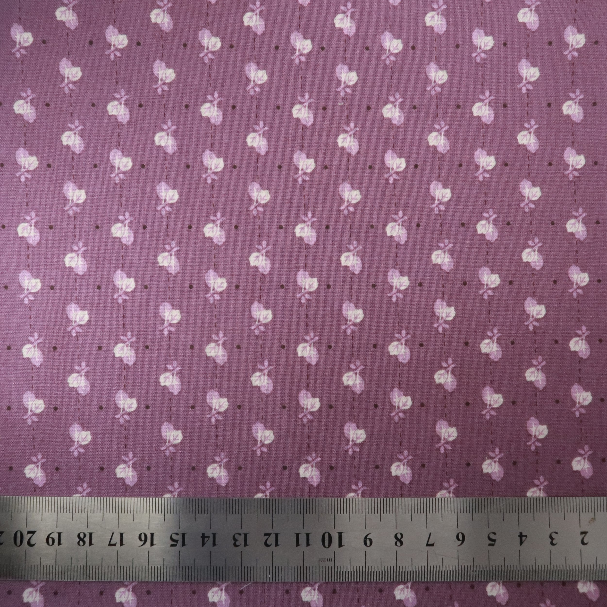 White and lavender leaves on purple fabric