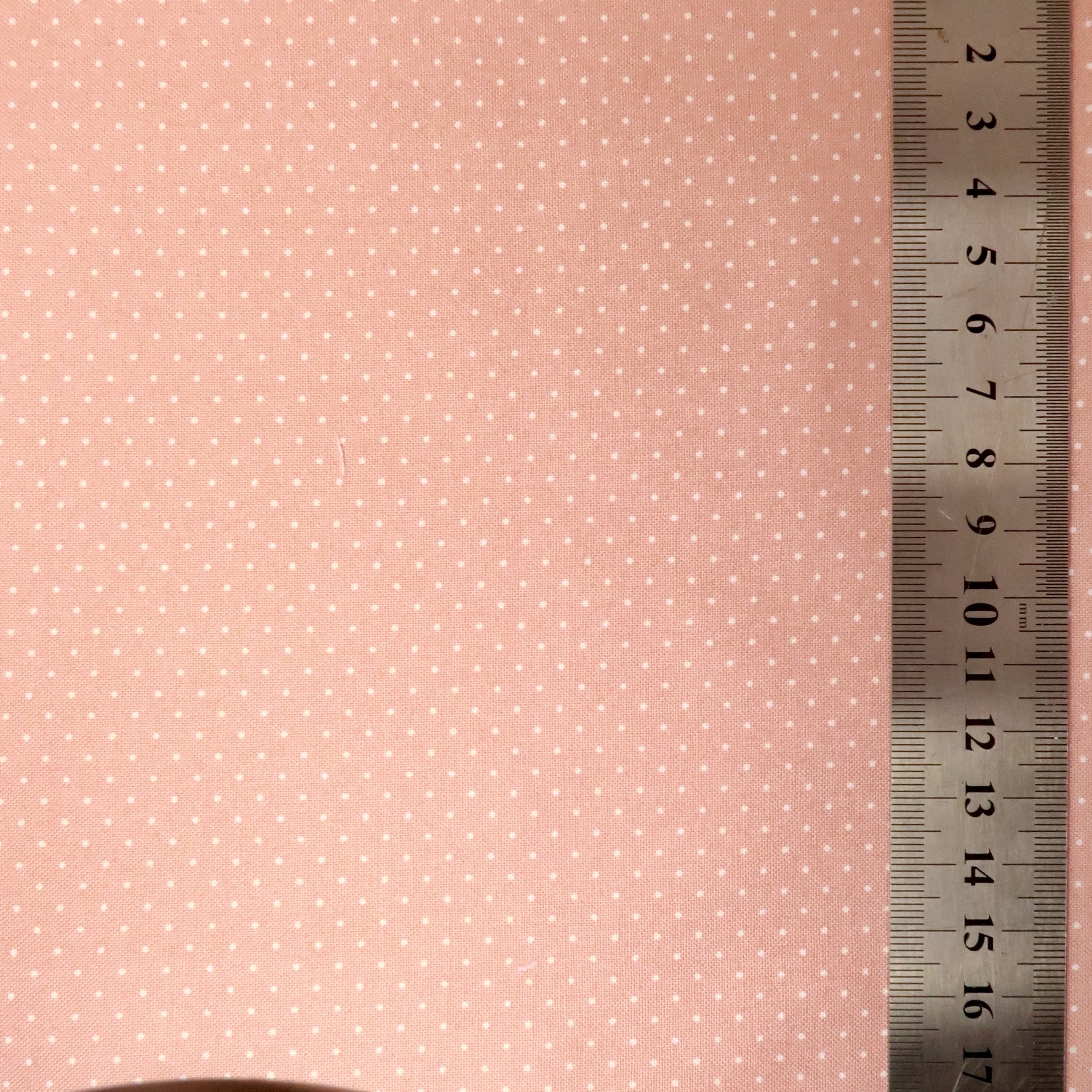 Tiny white dots on pink fabric