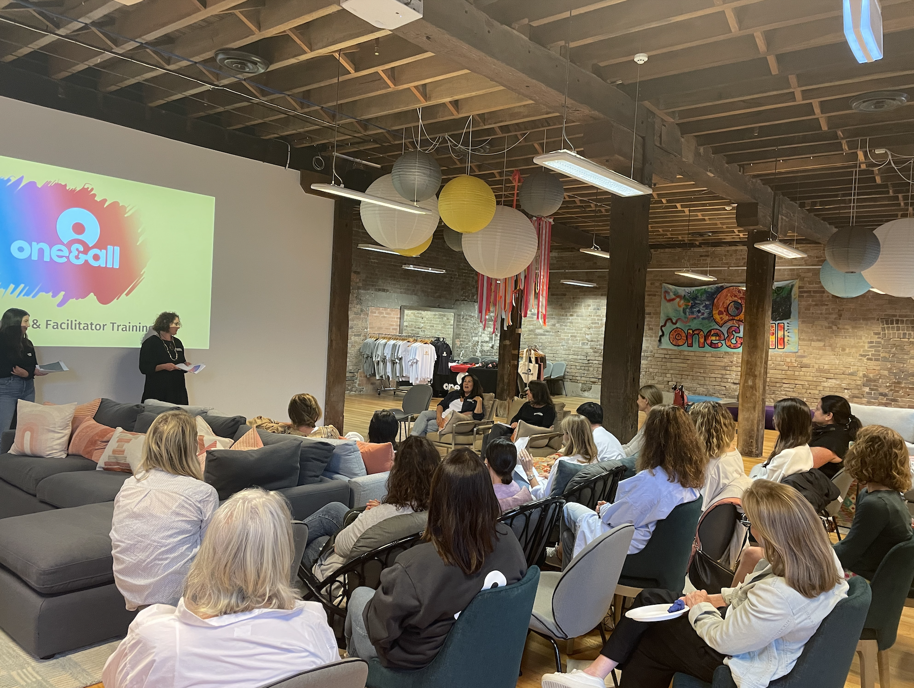 Volunteers at One&All hub listening to presentation