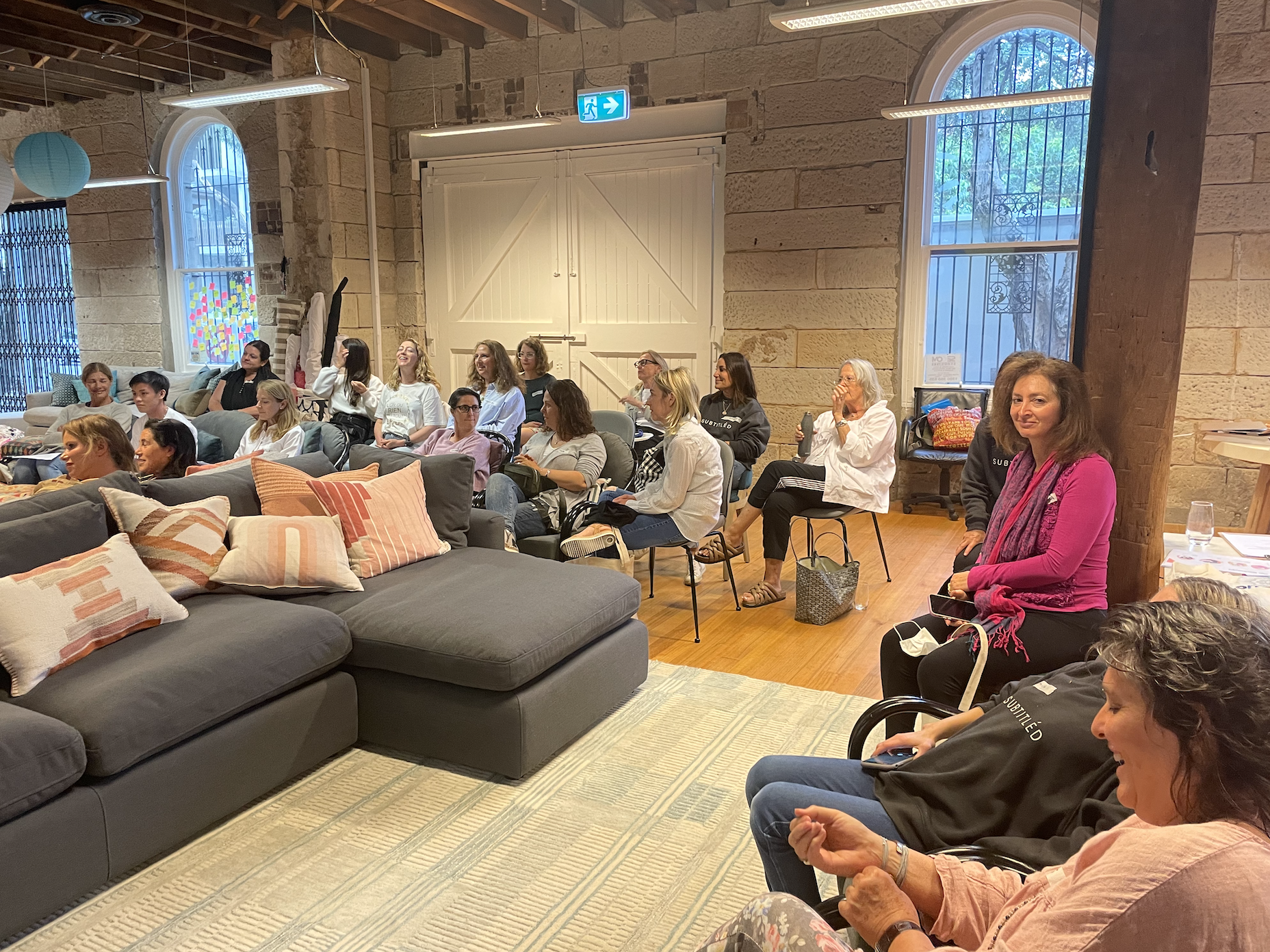 Lots of volunteers sitting and listening to presentation