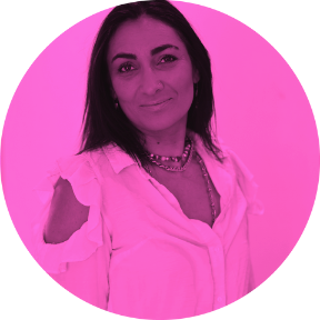 A woman with dark hair and a white top, smiling, in front of a pink circular background.