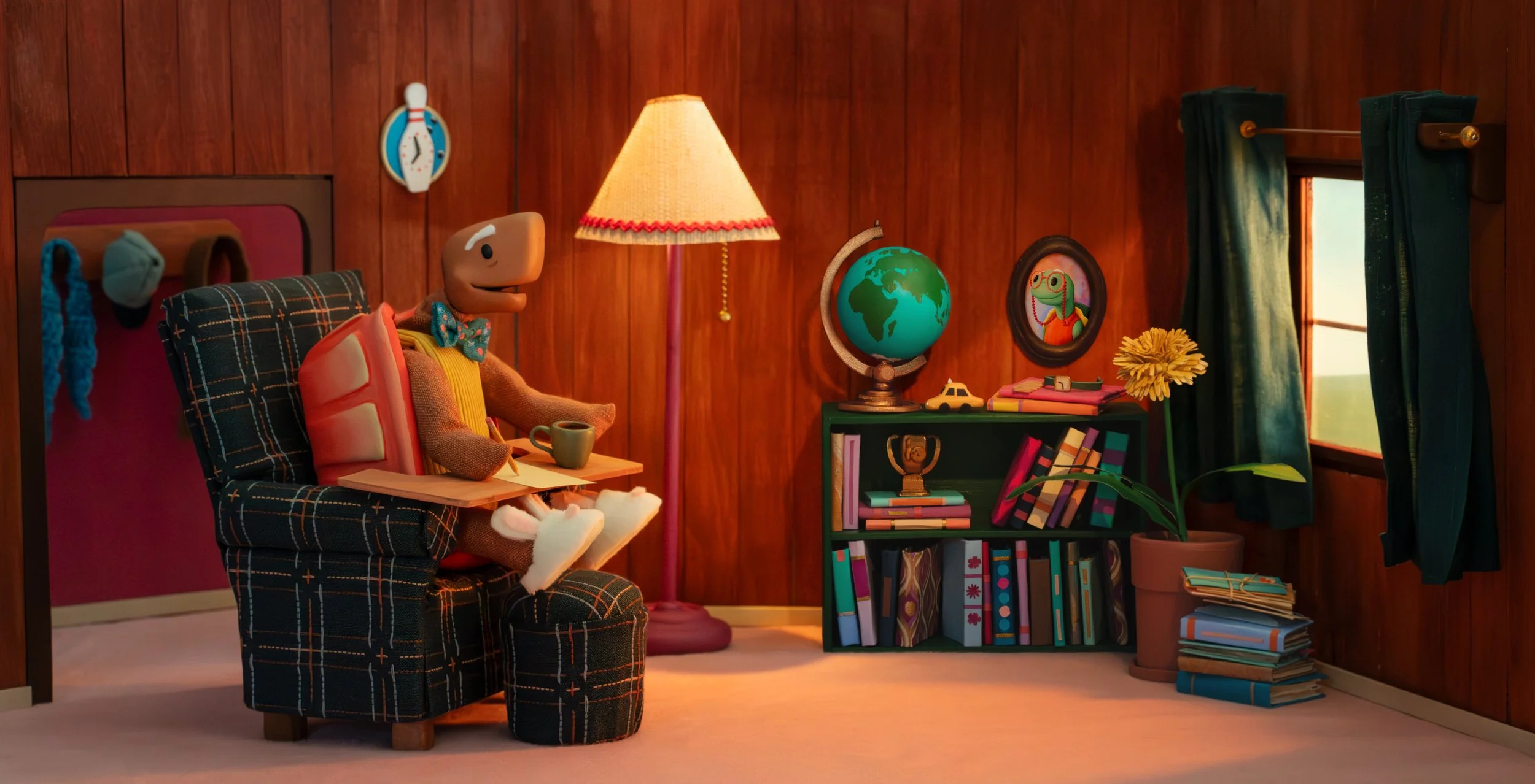 Slowly in his living room, writing a letter to Shirley. Illustration from Slowly and Shirley, a book by Spencer Lott and Grace Townley