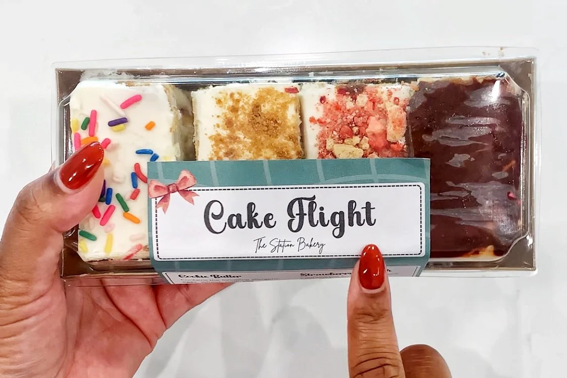 cake flight with 4 flavors in a windowed bakery box
