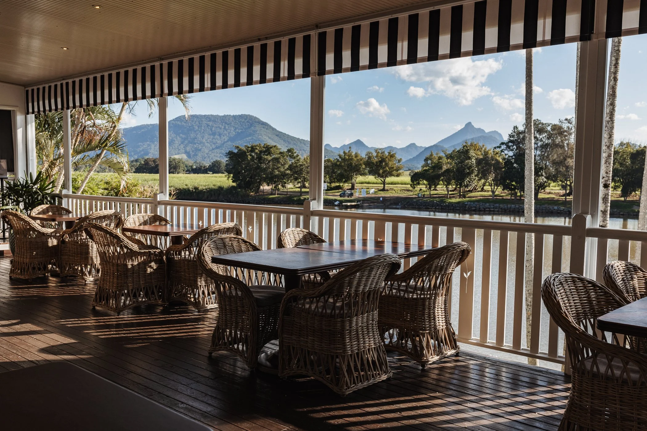 tables on verandah overlooking river and mountains
