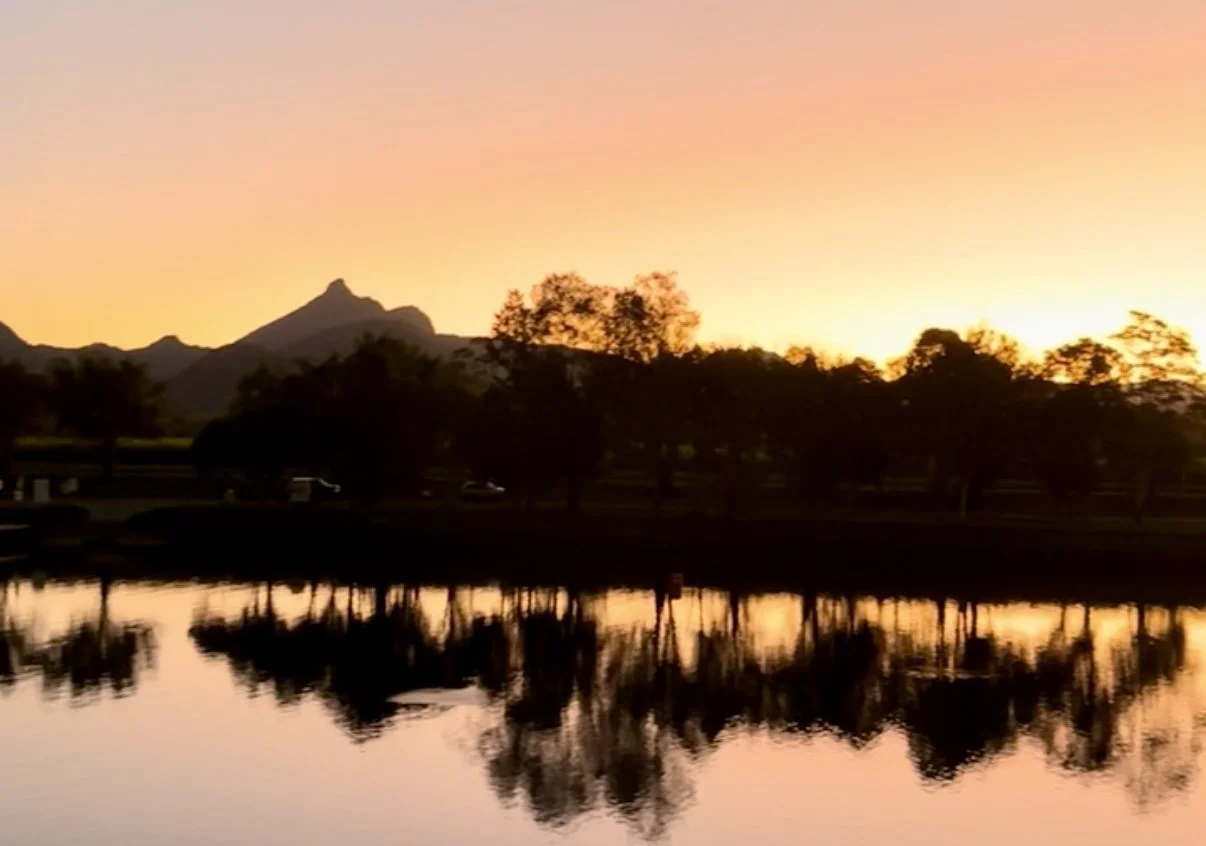 sunset overlooking the river and mountains