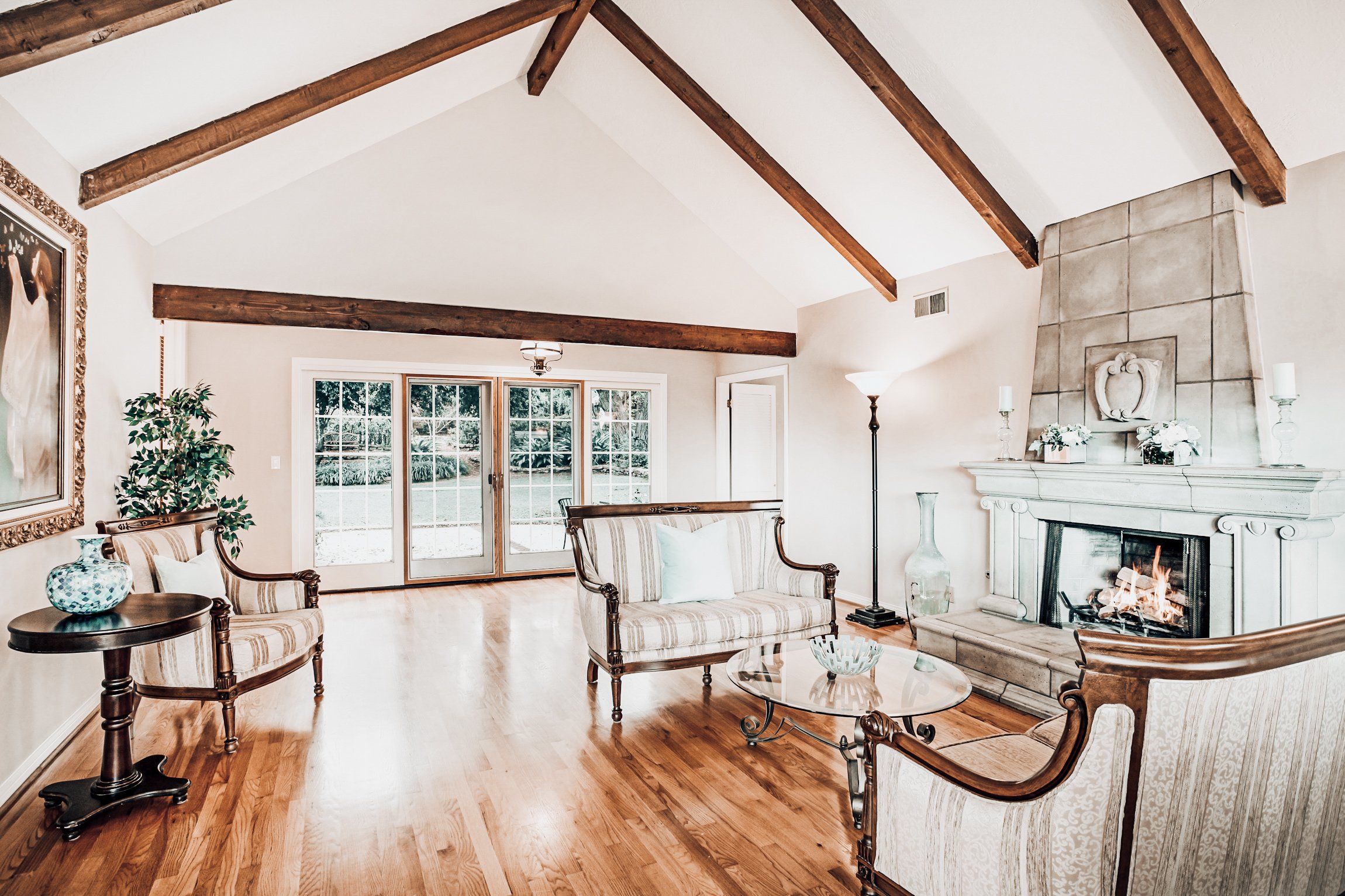 Professional photography of a living room with hardwood floors and vaulted ceilings of a Los Angeles home for real estate marketing.