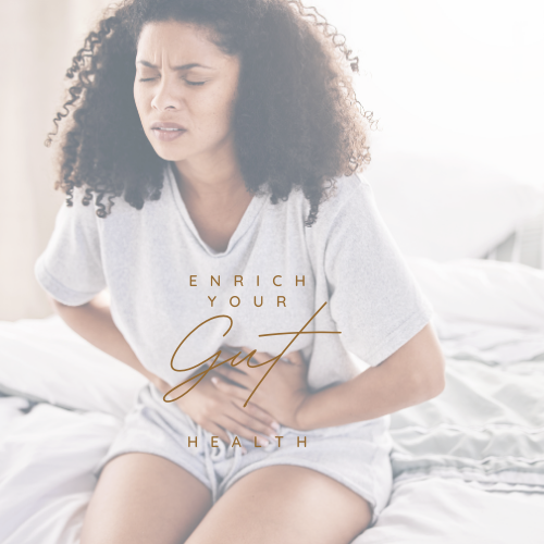 Woman sitting on a bed, holding her stomach with a pained expression, text reads "Enrich Your Gut Health."