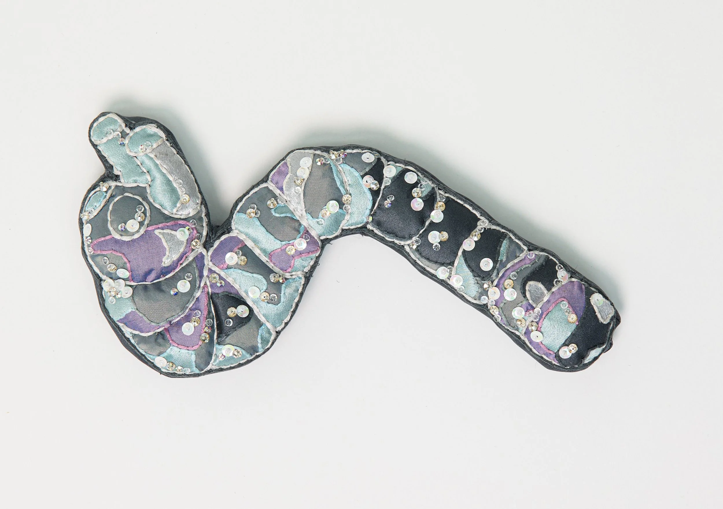 "My Glass Caterpillar" (2025), hand-embroidered and embellished silk and other textiles, 12cm x 22.5cm x 3cm, £800